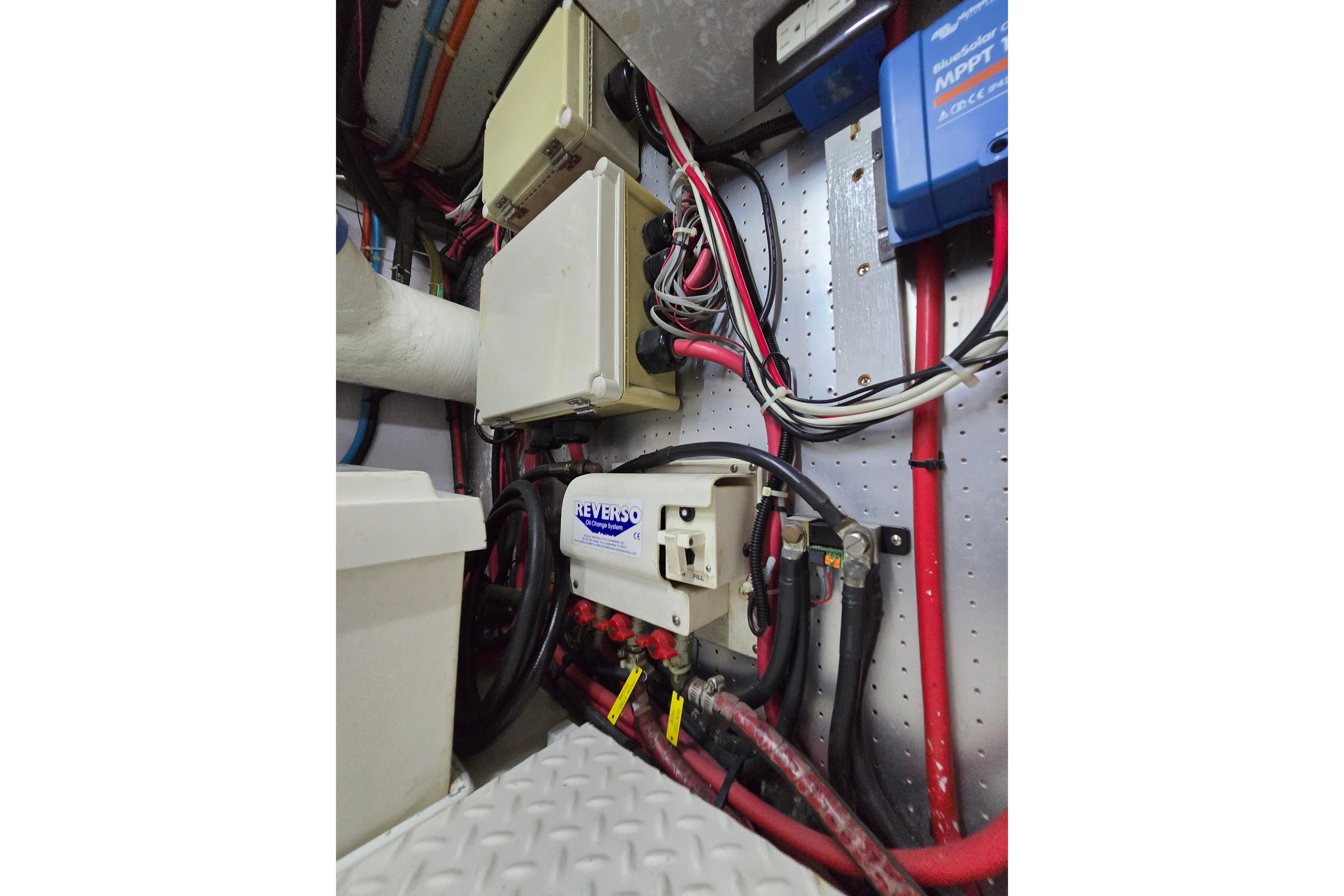 Electrical system inside a 2004 Grand Harbour 58 yacht, featuring wiring and control boxes.