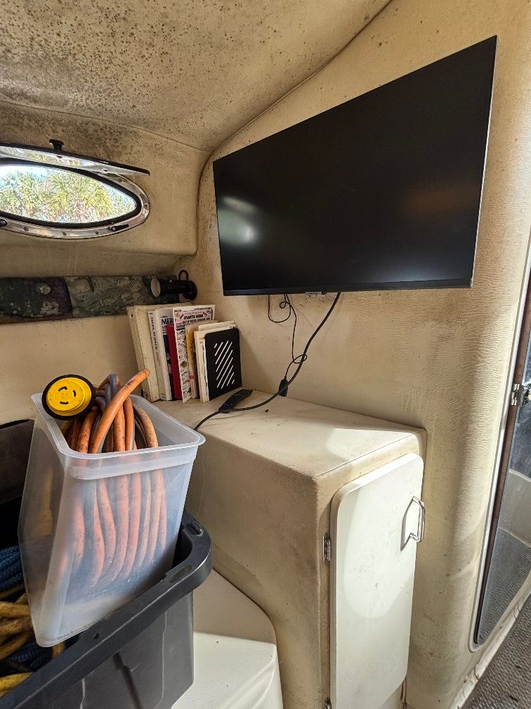 Interior of a 1997 Donzi 275LXC with TV and cables.