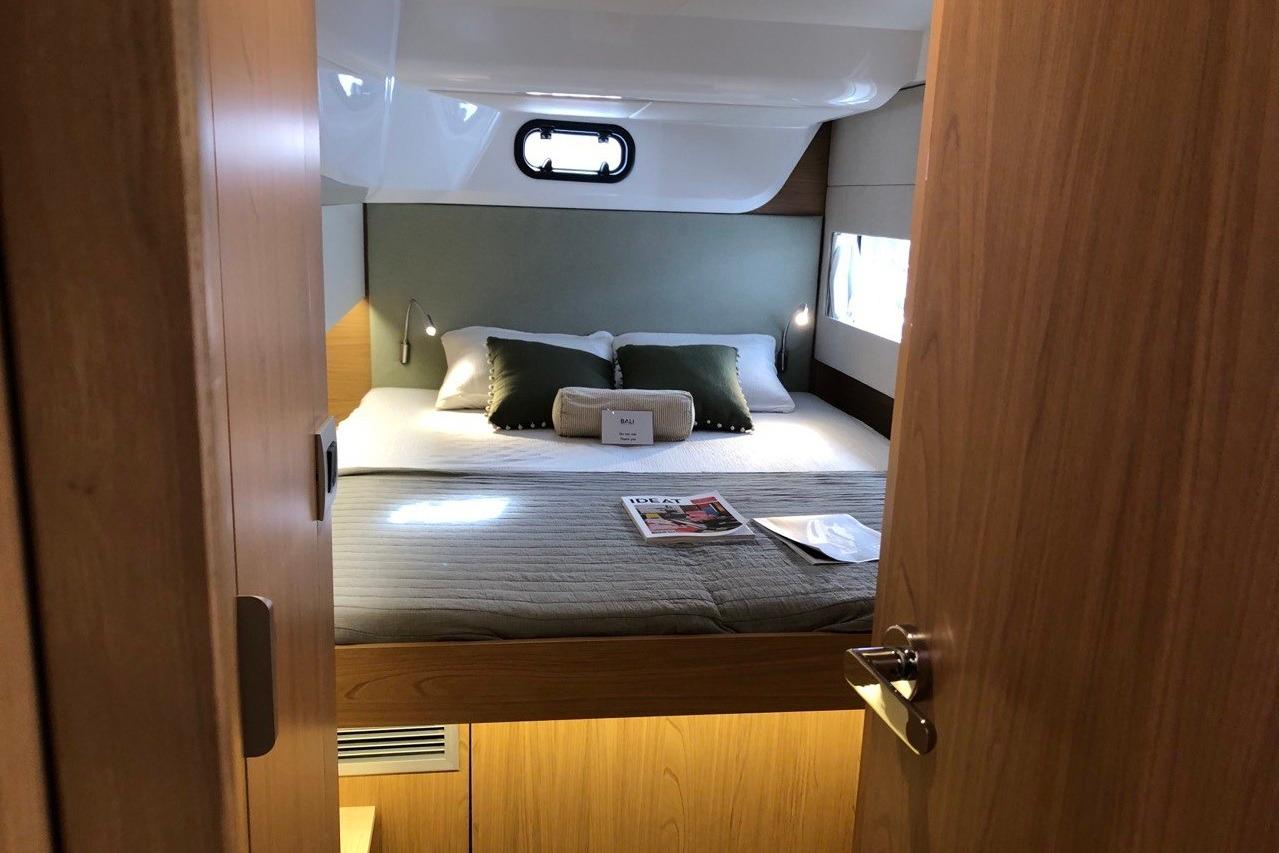 Cozy bedroom interior in 2026 Bali CATSMART yacht with modern design and natural lighting.