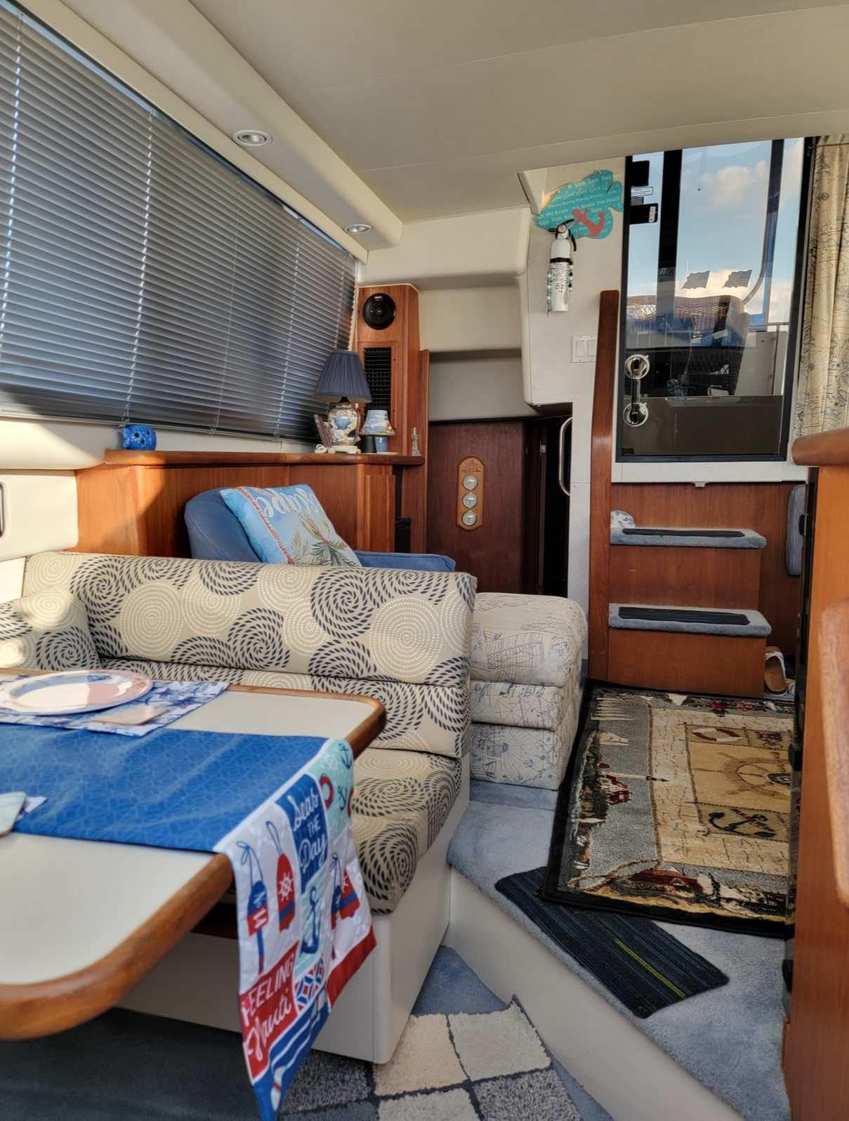 Interior of a 1992 Carver 33 Aft Cabin with cozy seating and nautical decor.