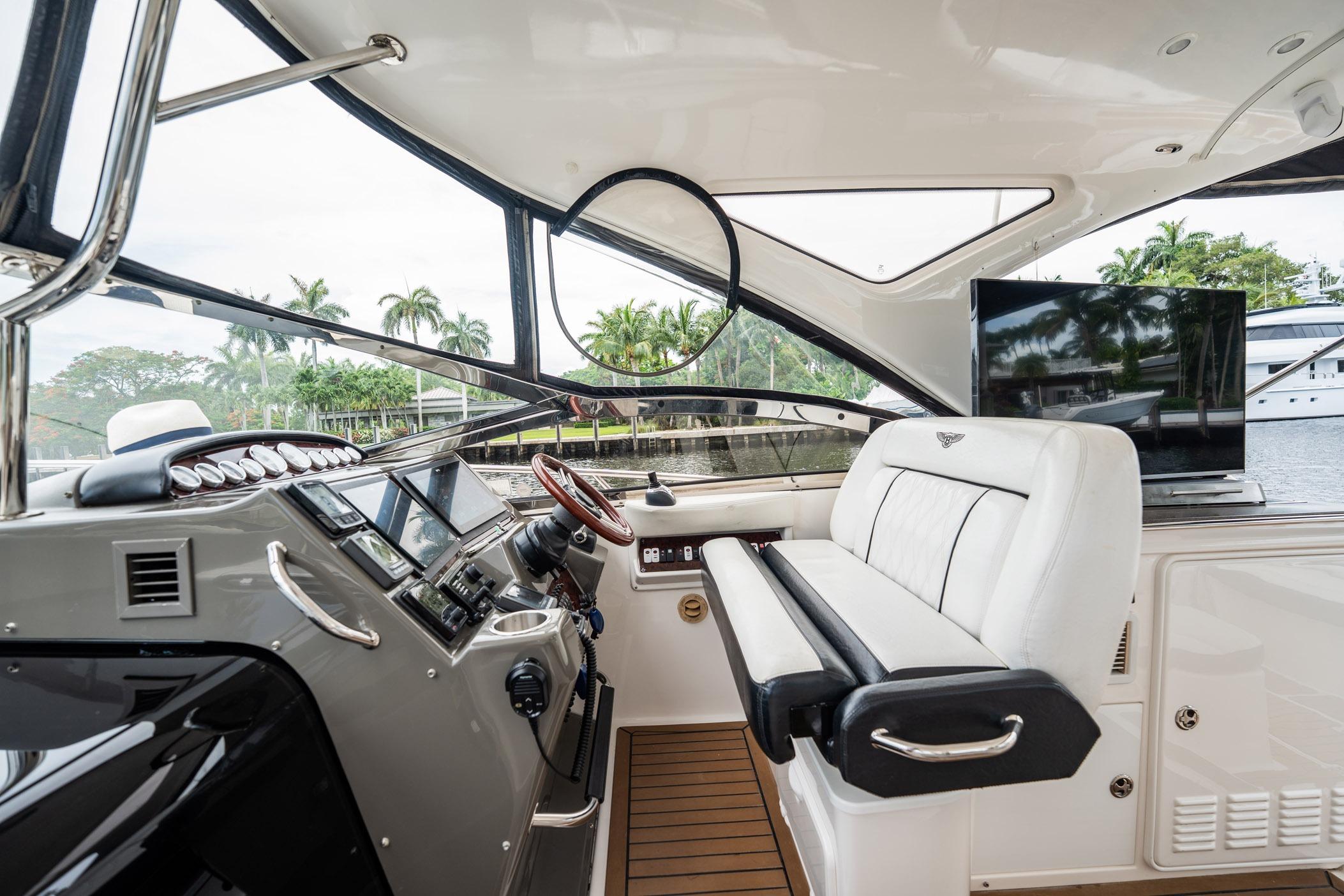 Luxurious 2008 Regal Commodore 4460 yacht interior with helm, seating, and waterfront view.