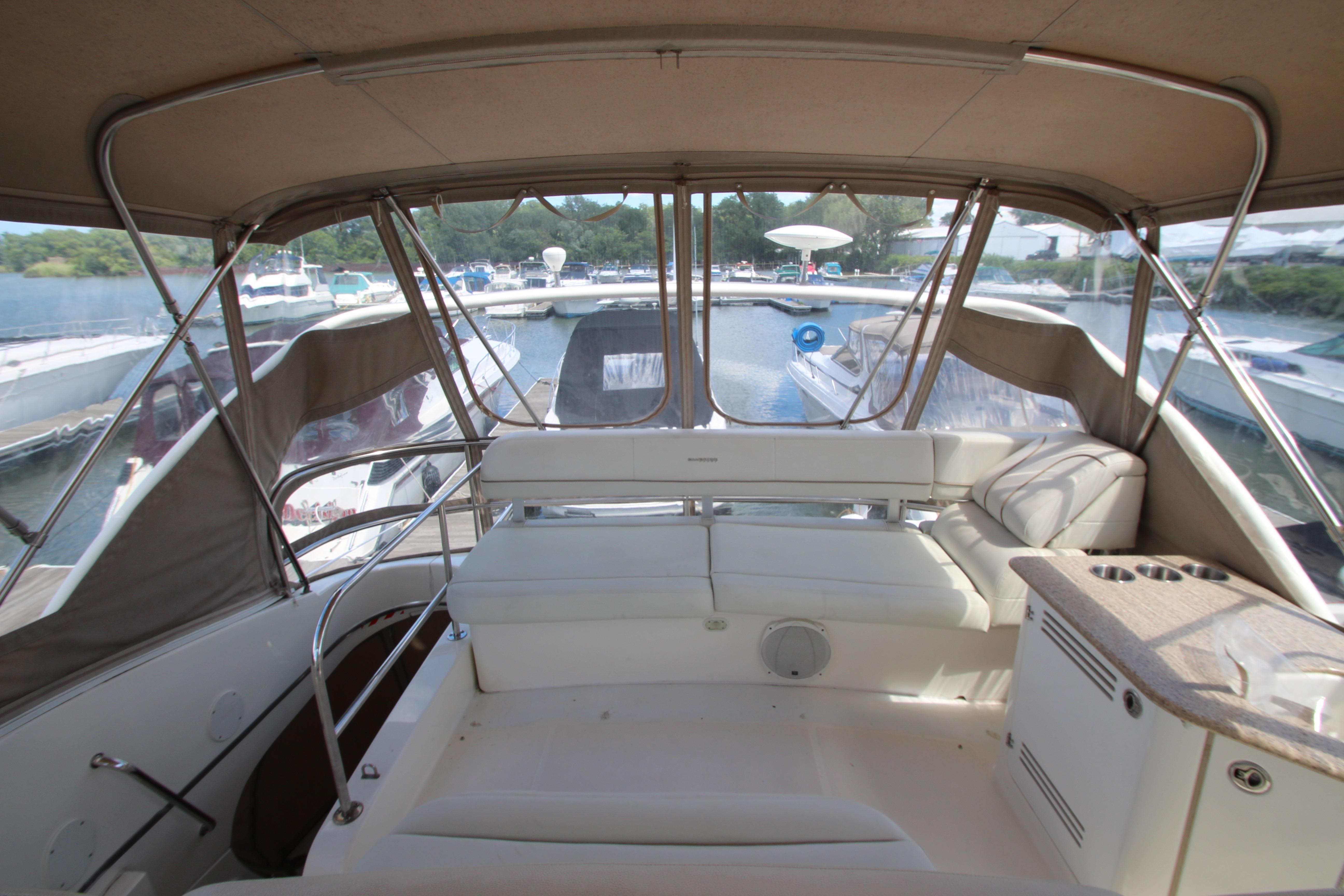 2006 Silverton 38 Sport Bridge interior with seating and marina view.