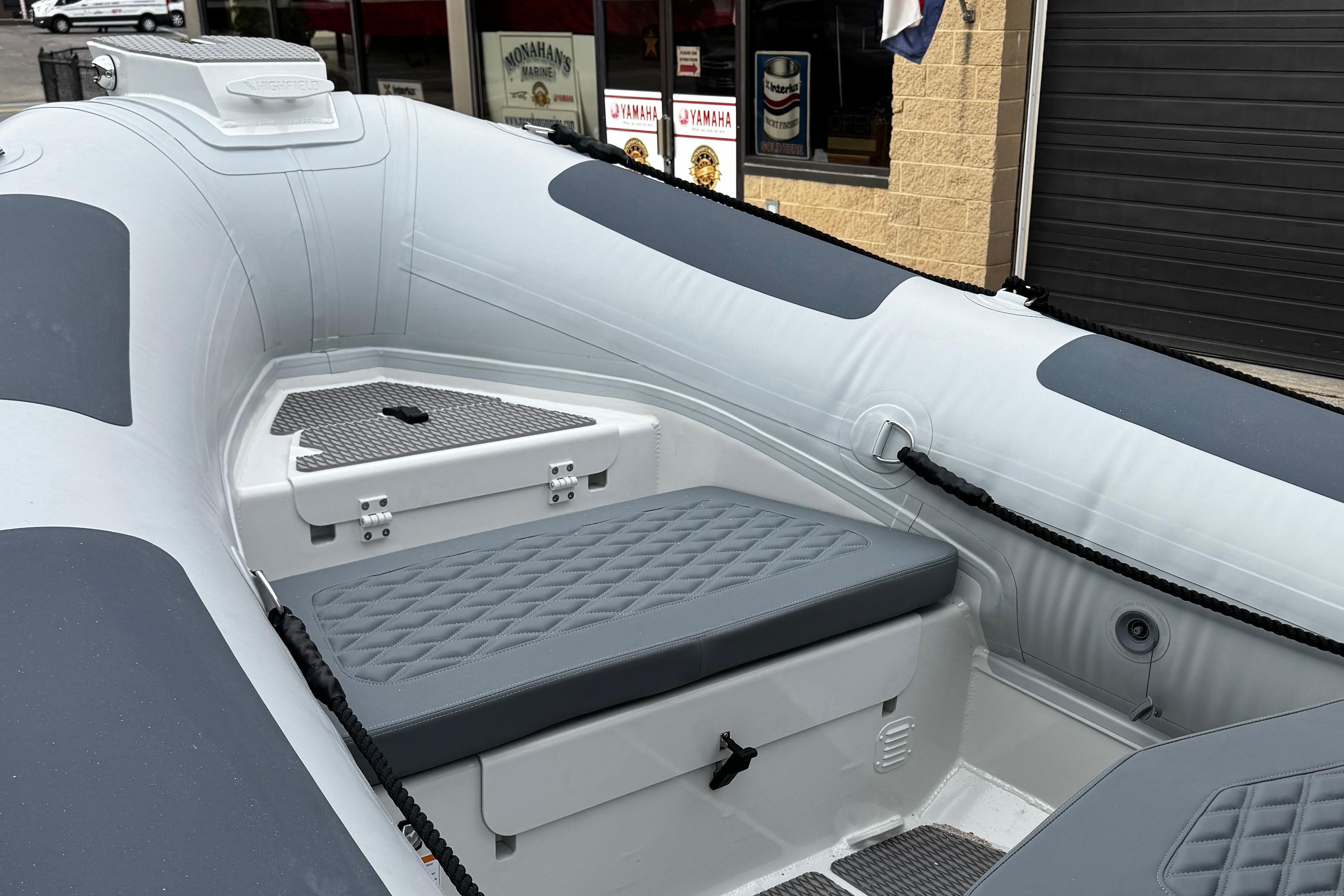 2026 Highfield Patrol 600 boat interior with gray seating and storage compartments.