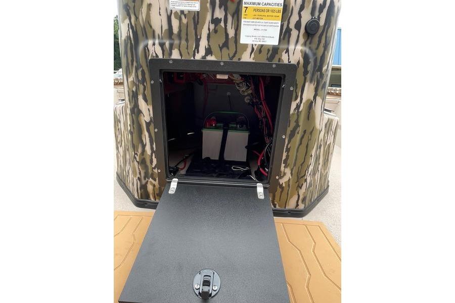Open storage compartment of 2026 Avid 21 FSX boat with camouflage exterior.