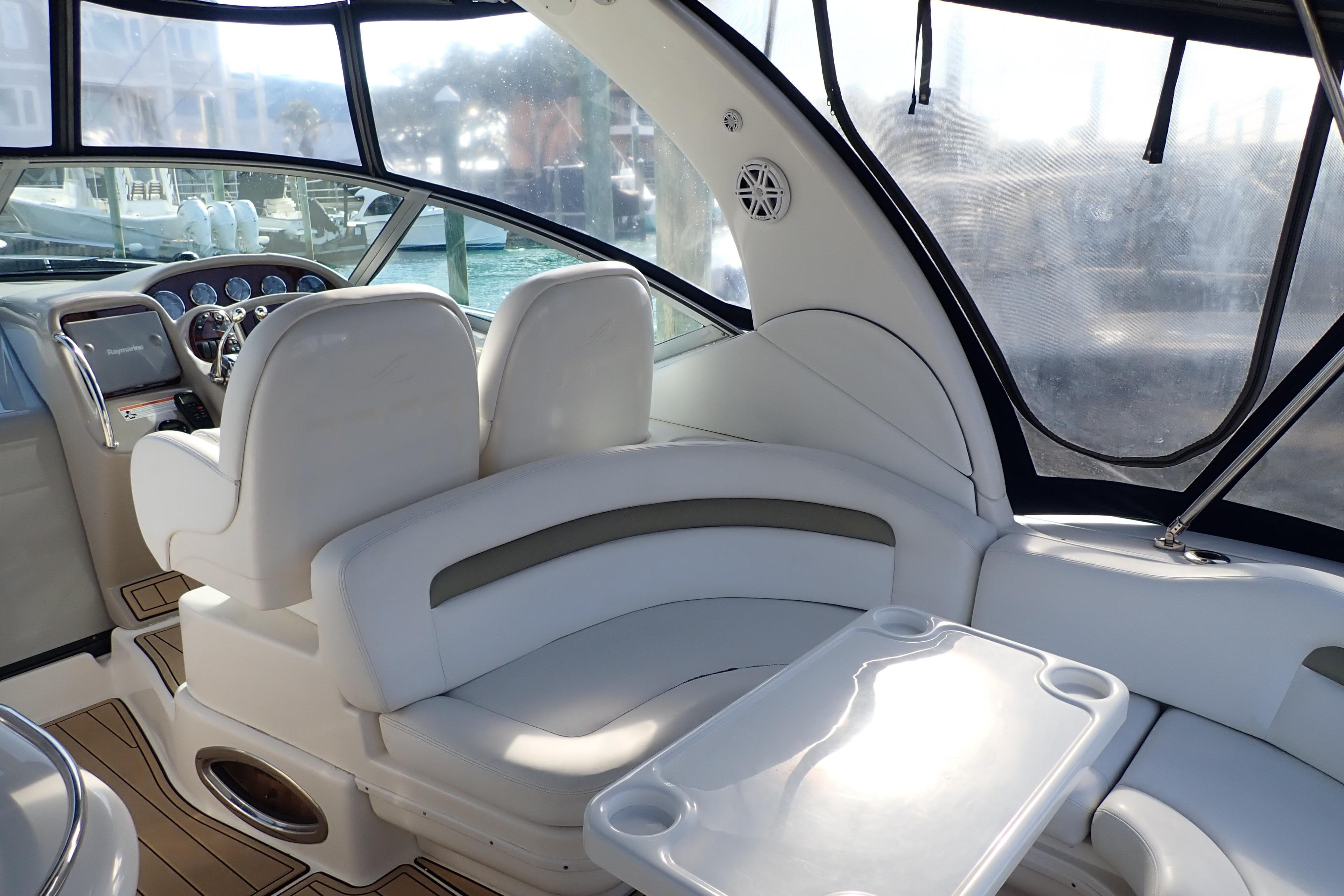 Interior of 2006 Sea Ray 340 Sundancer yacht with white seating and helm.