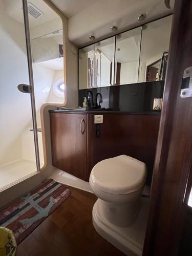 2009 Ovation 52 yacht bathroom with shower, vanity, and toilet.