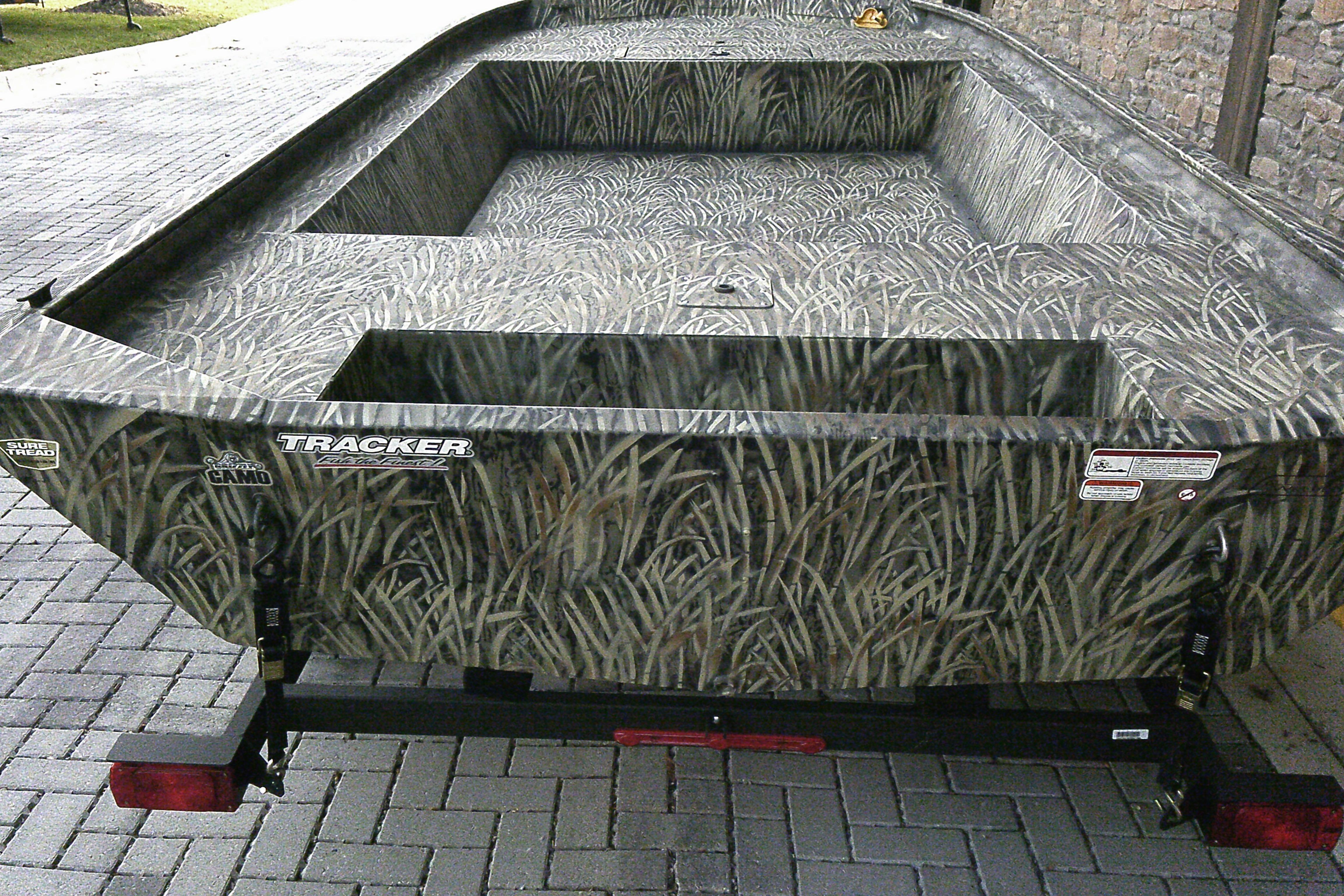 2025 Tracker Grizzly 1860 Utility boat with camouflage design on a trailer.
