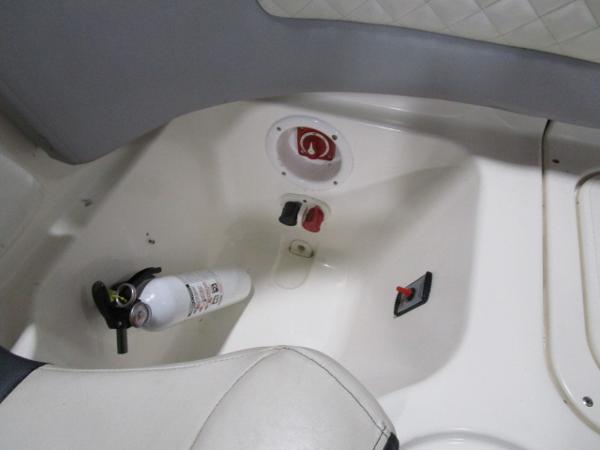 Interior of 2017 Larson 292 LXI boat with fire extinguisher and control panel.