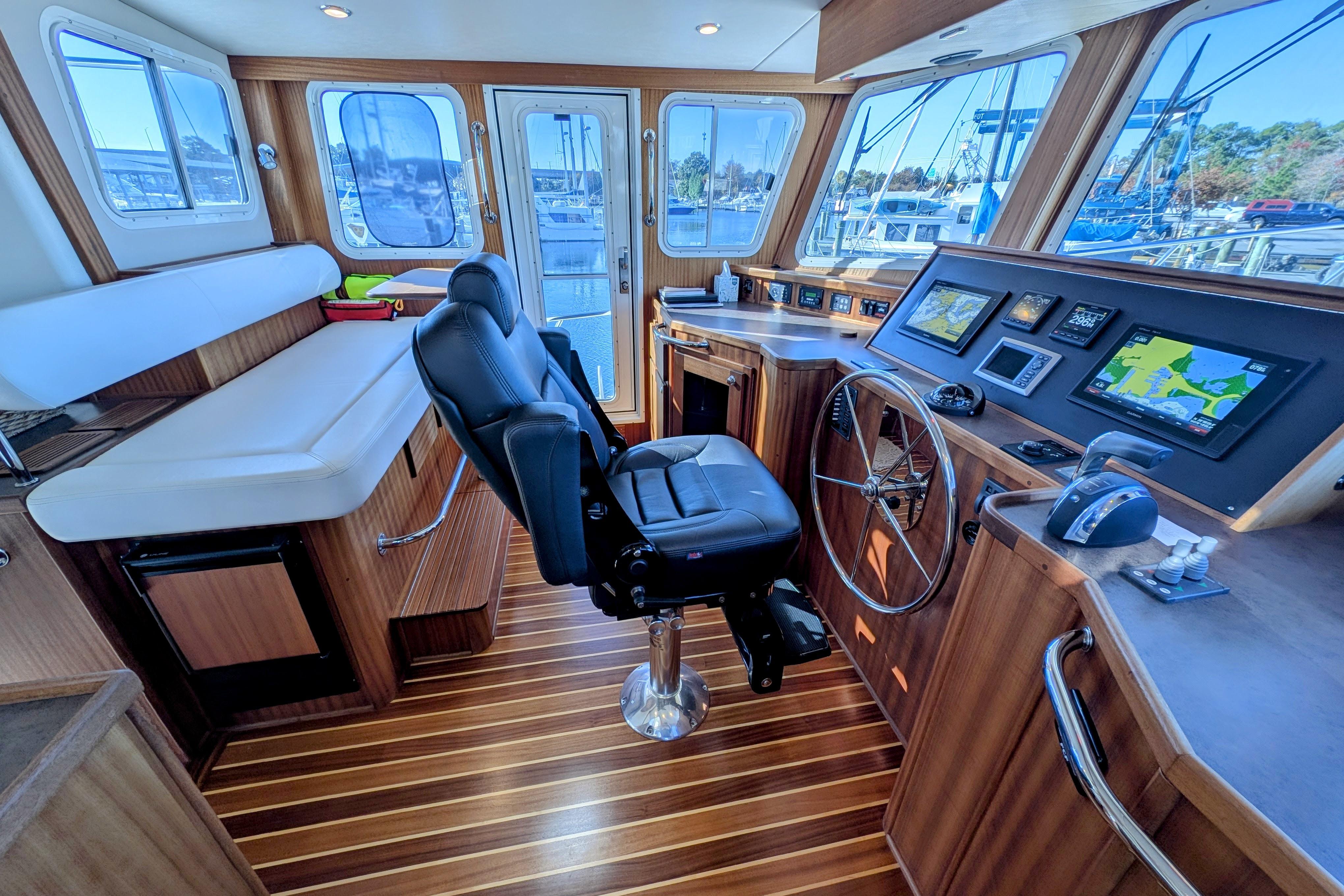 Pilothouse of 2015 American Tug 435 with navigation equipment and captain's chair.
