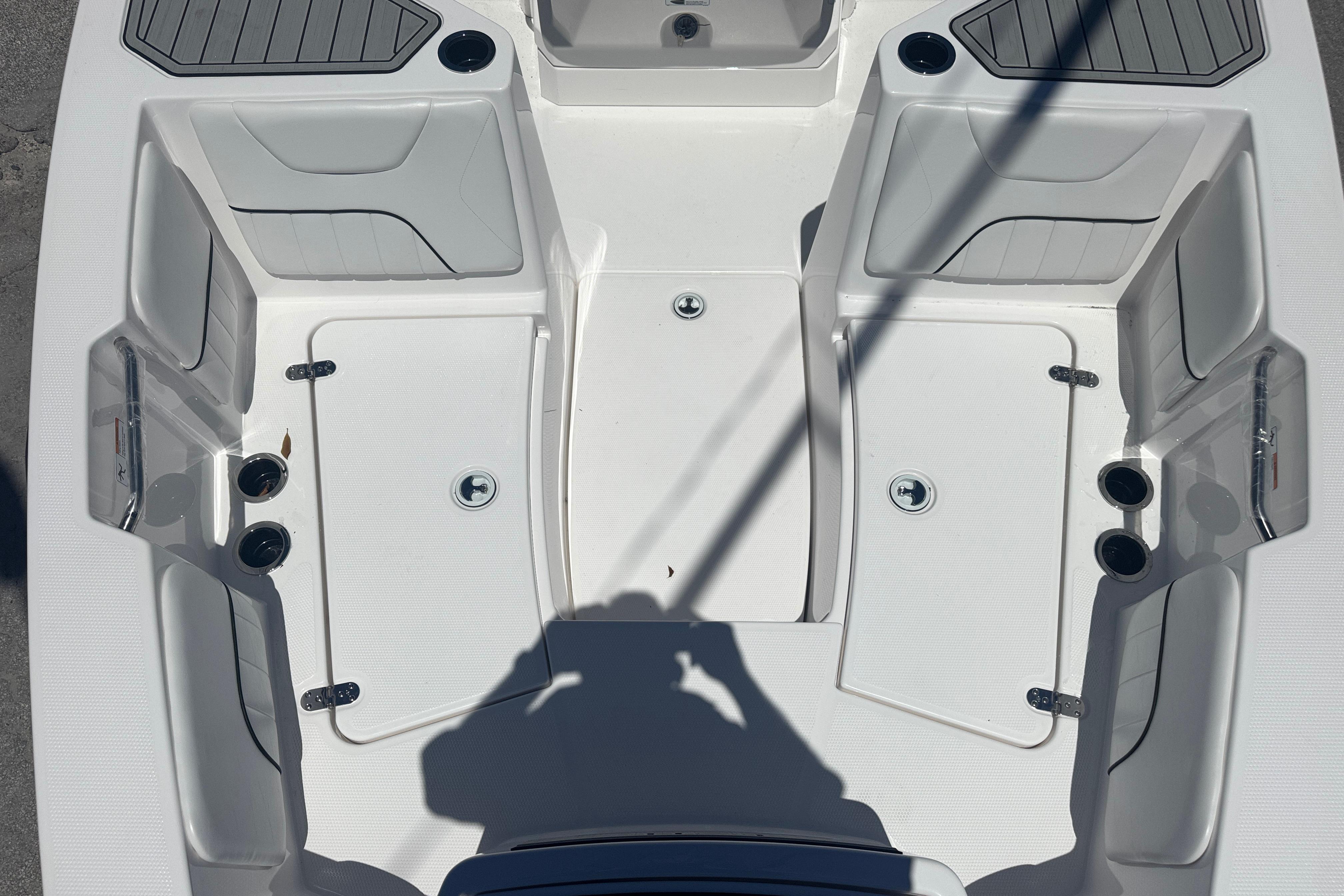 2026 Yamaha Boats 220 FSH Sport interior, featuring seating and storage compartments.