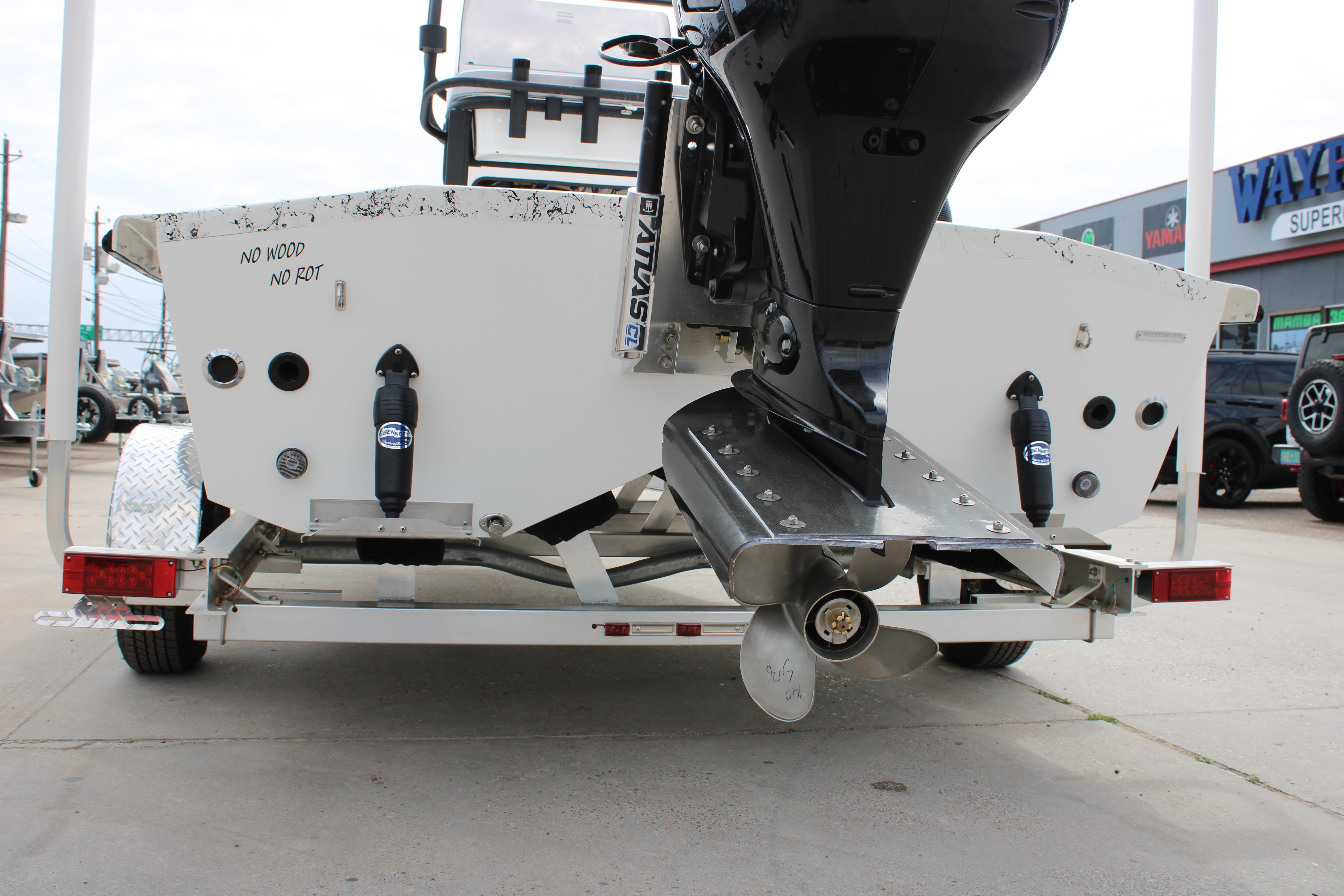 Rear view of 2026 Freedom Boats 19 PATRIOT with motor and trailer.