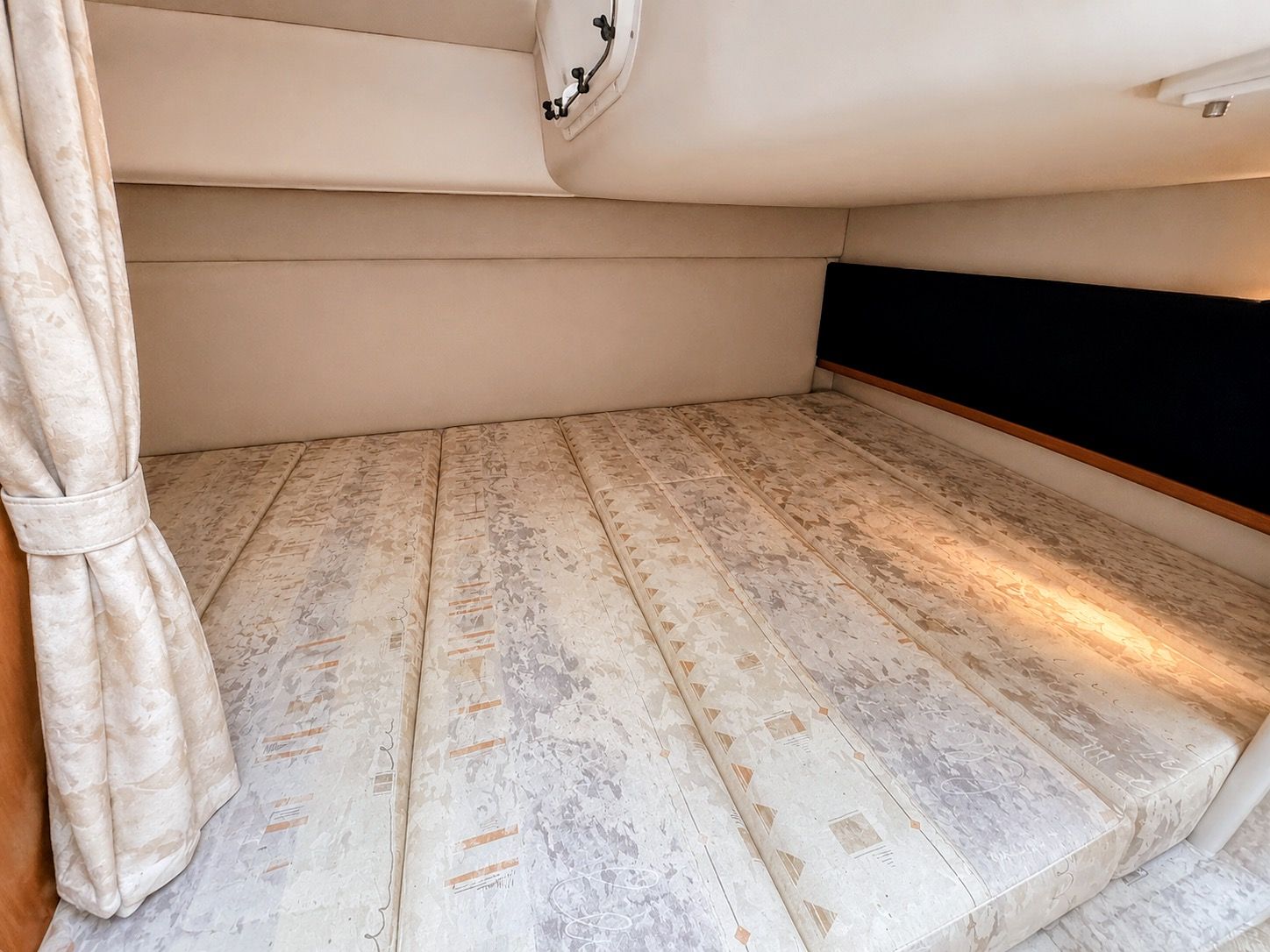 Interior of a 2001 Four Winns 298 Vista with a large, cushioned sleeping area.