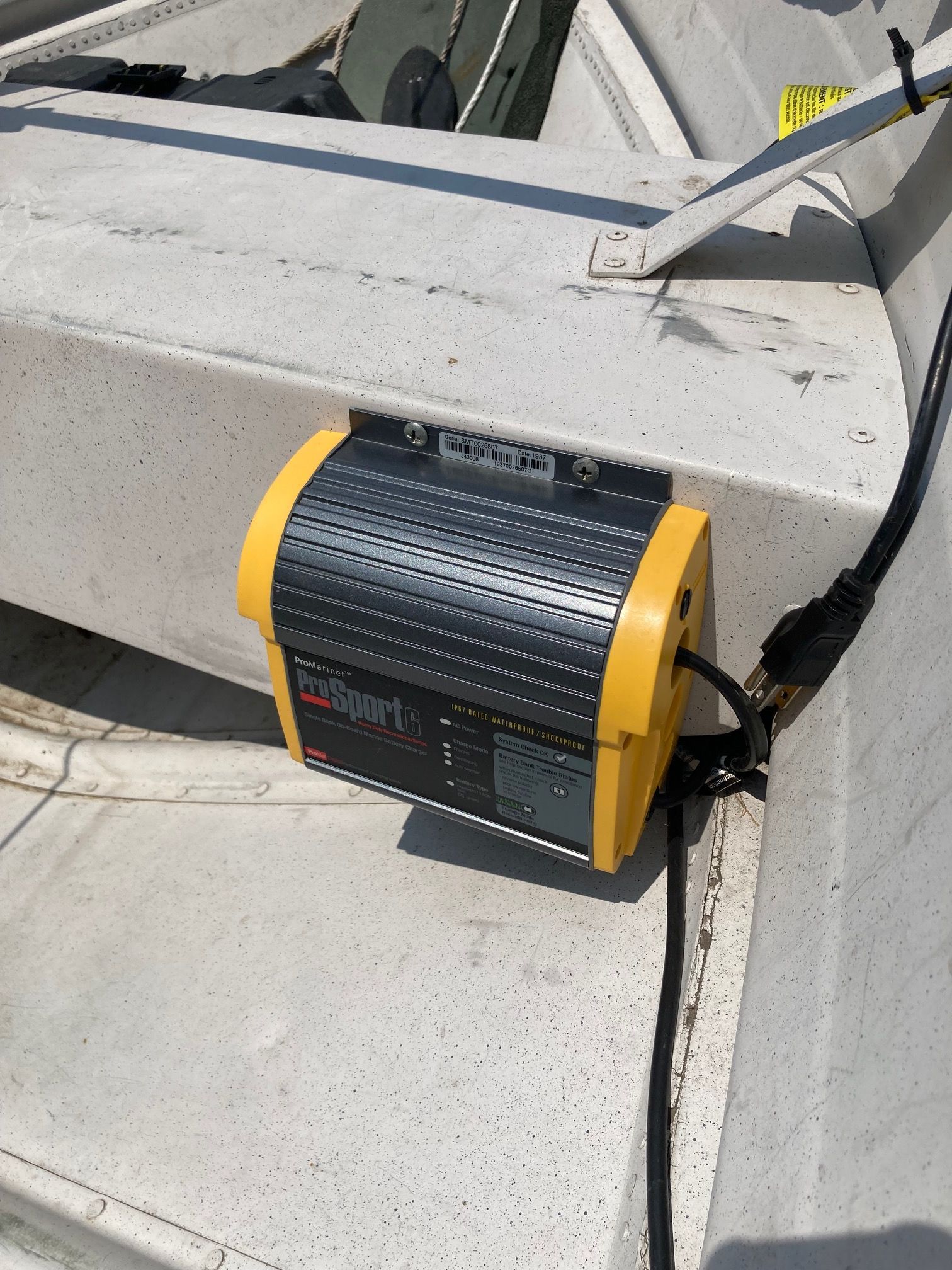 A charger is mounted on a white boat.