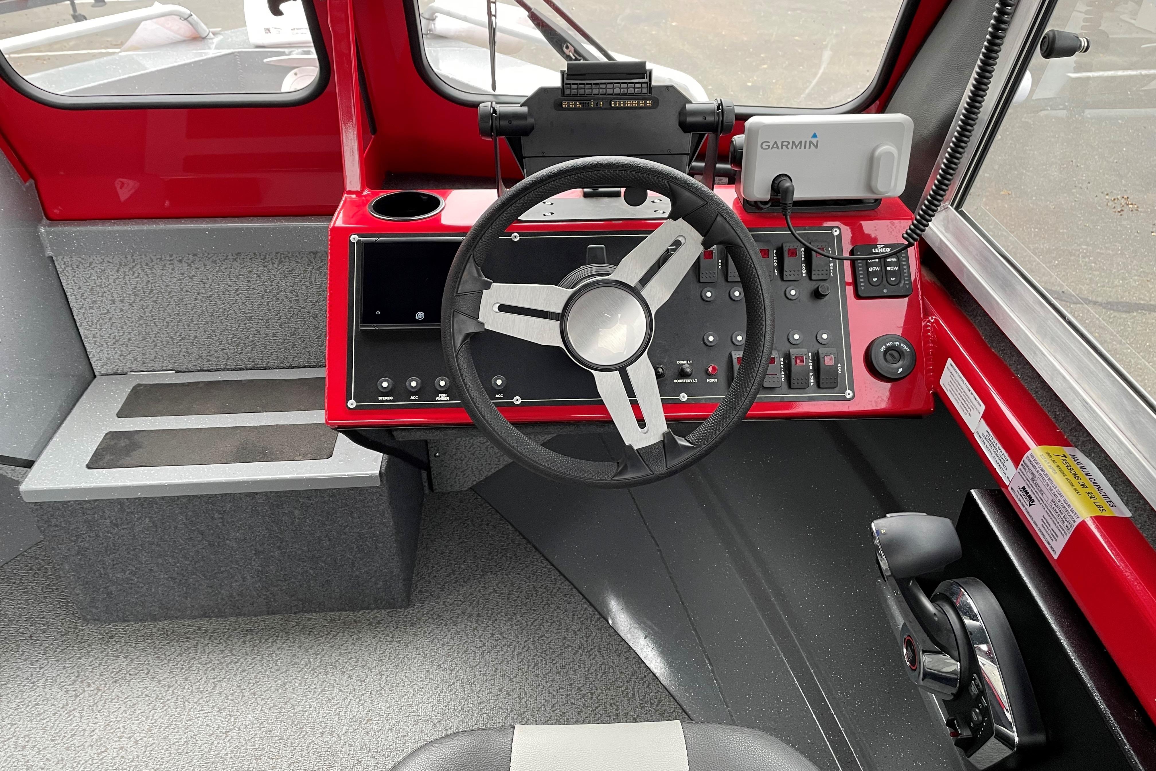 2024 Spartan 200 Astoria boat cockpit with steering wheel and control panel.