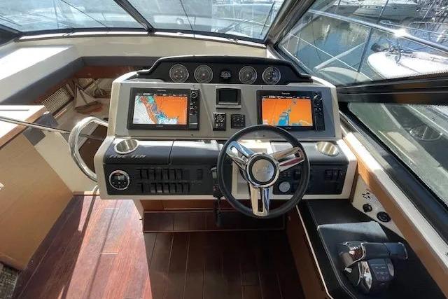 Helm of 2016 Sea Ray Sundancer 510 with dual navigation screens and modern controls.