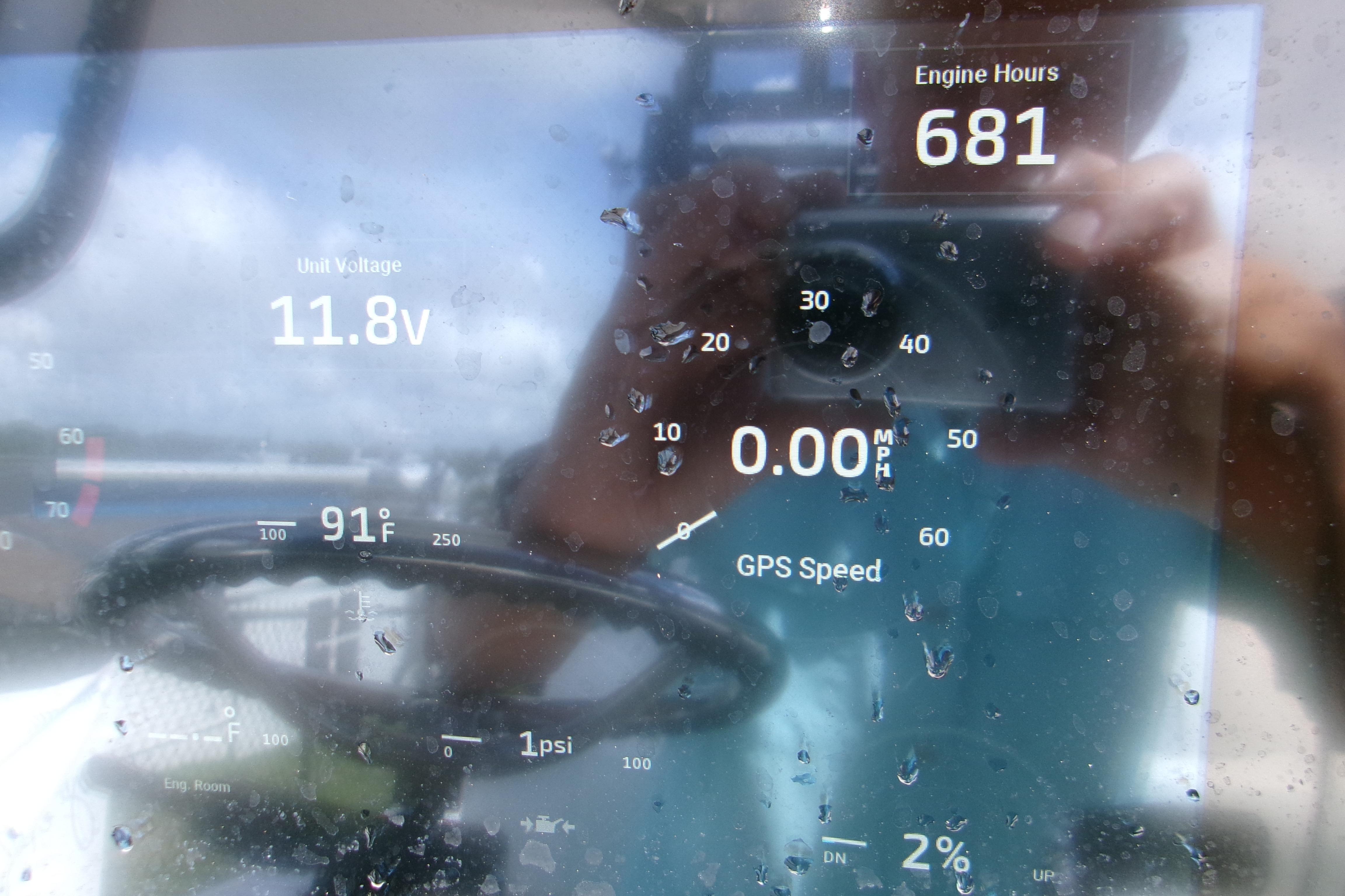 Close-up of a 2024 Sportsman Masters 227 Bay Boat dashboard display showing engine hours and voltage.