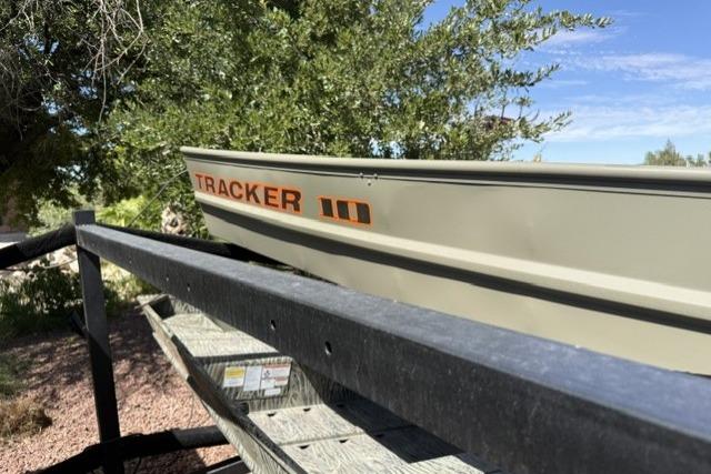 2026 Tracker Grizzly 10 Jon boat on trailer, under tree, sunny day.