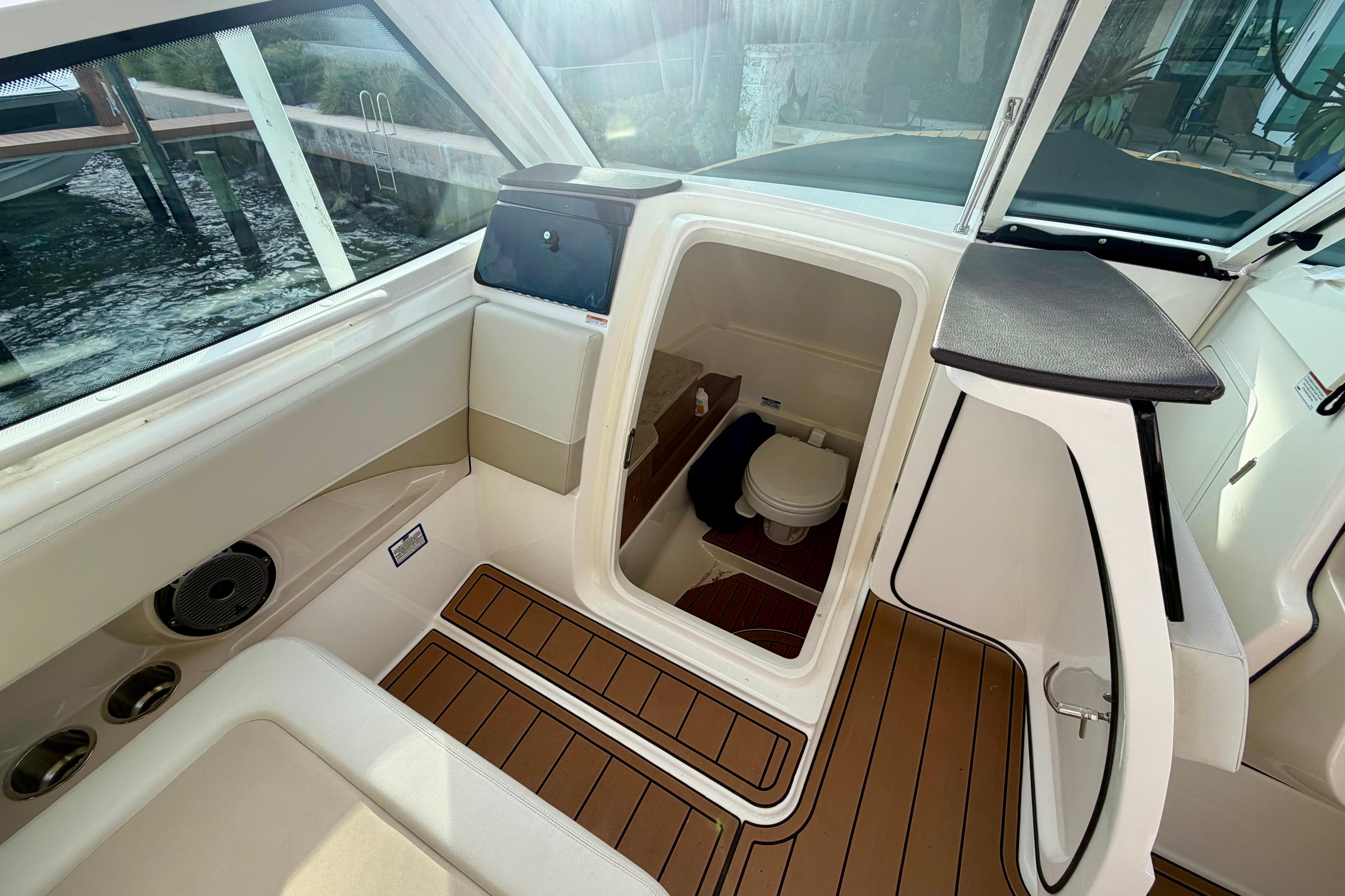 2022 Boston Whaler 280 Vantage boat interior with cabin and toilet, featuring sleek design.