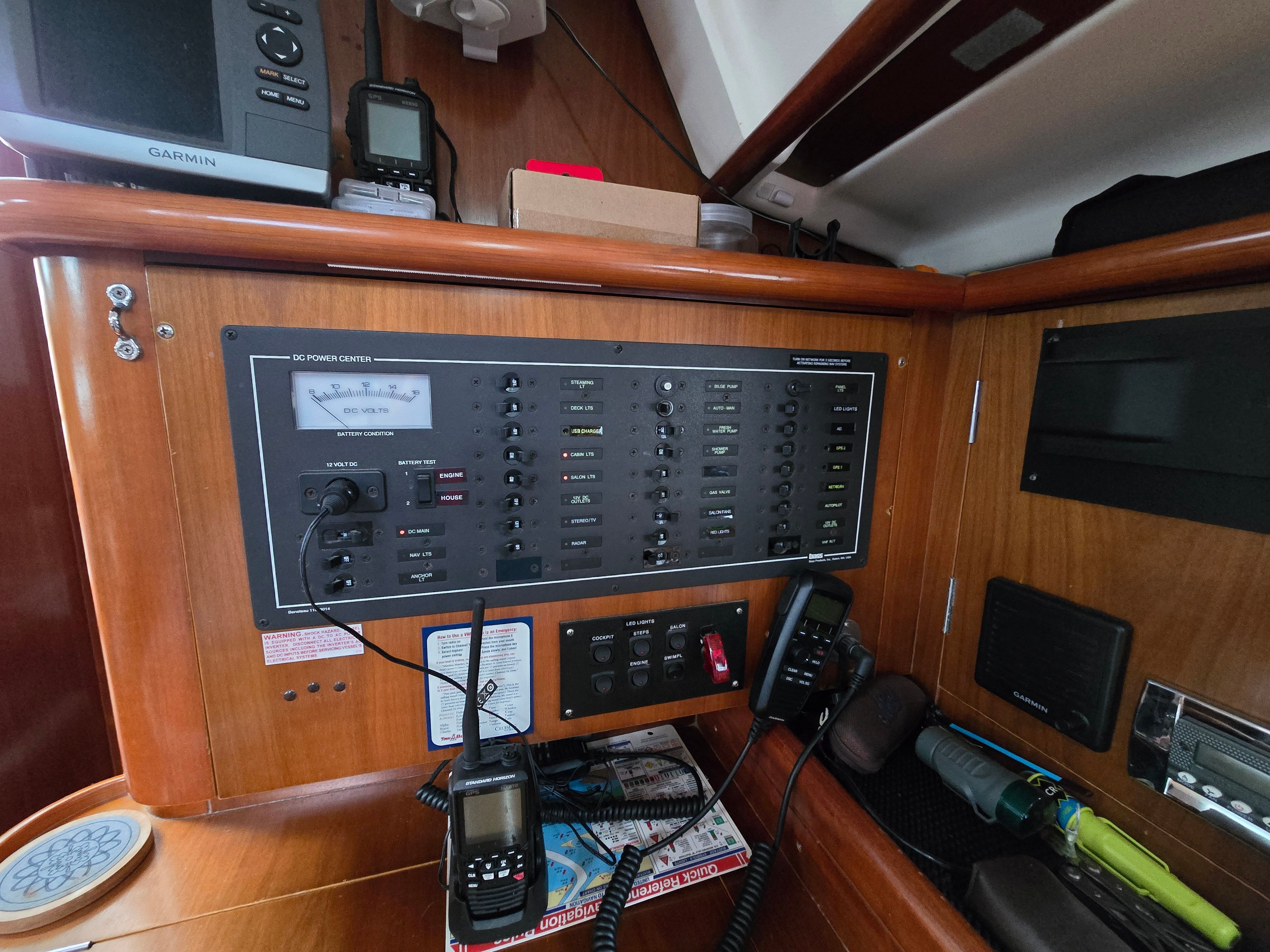 Interior view of a boat with a control panel and navigation equipment.