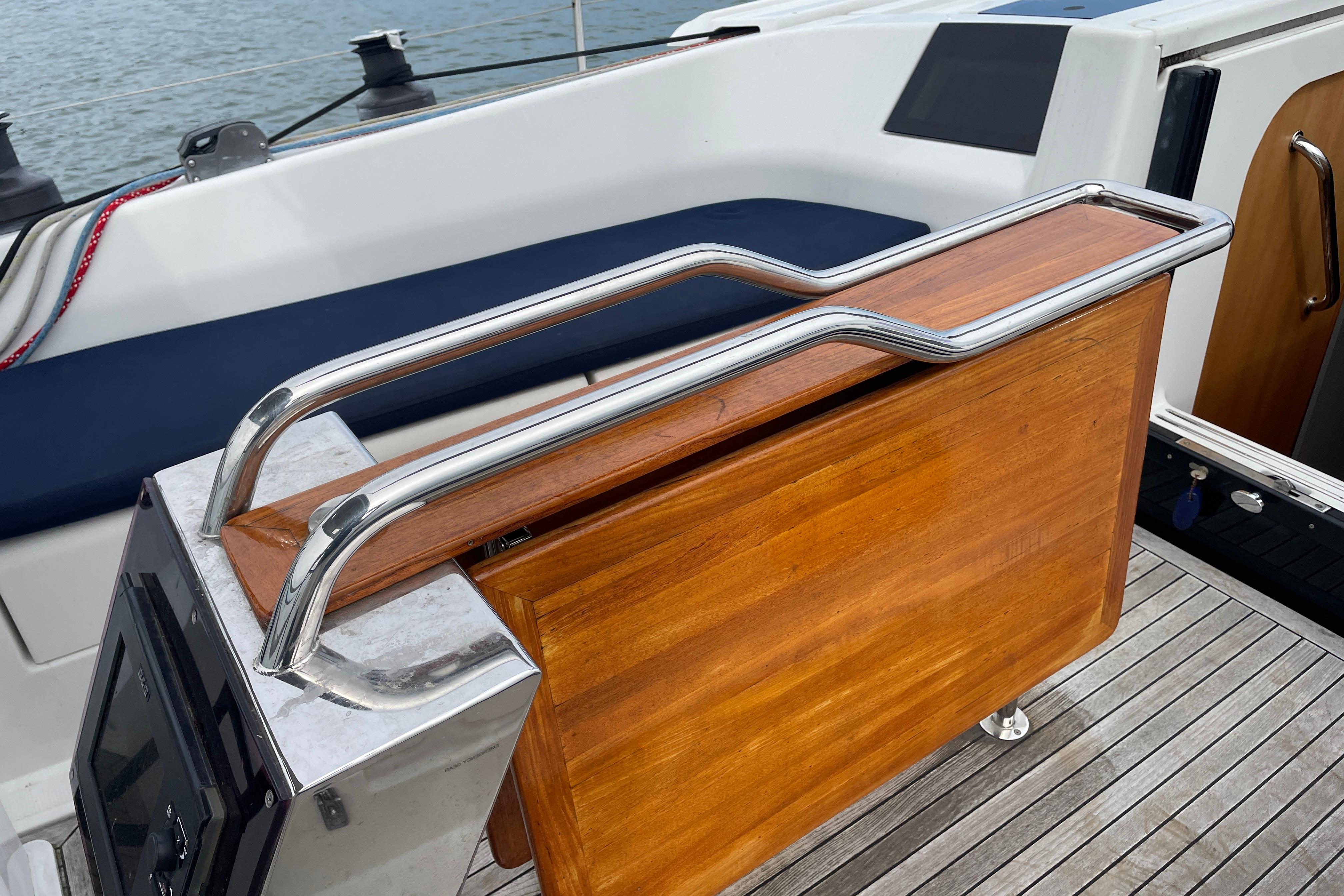 Cockpit of 2014 Hanse 415 yacht with wooden table and stainless steel handrails.