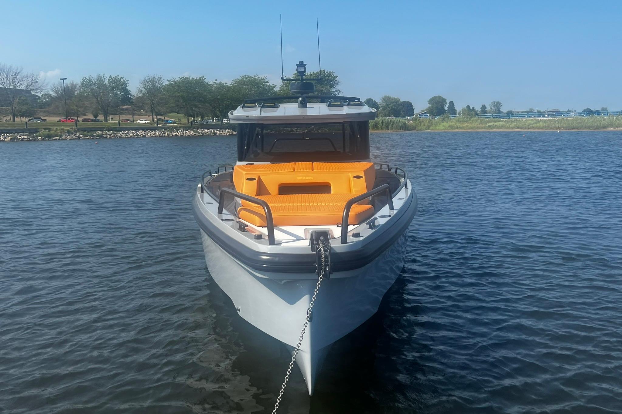 2024 BRABUS Shadow 900 XC Cross Cabin boat docked on calm water.