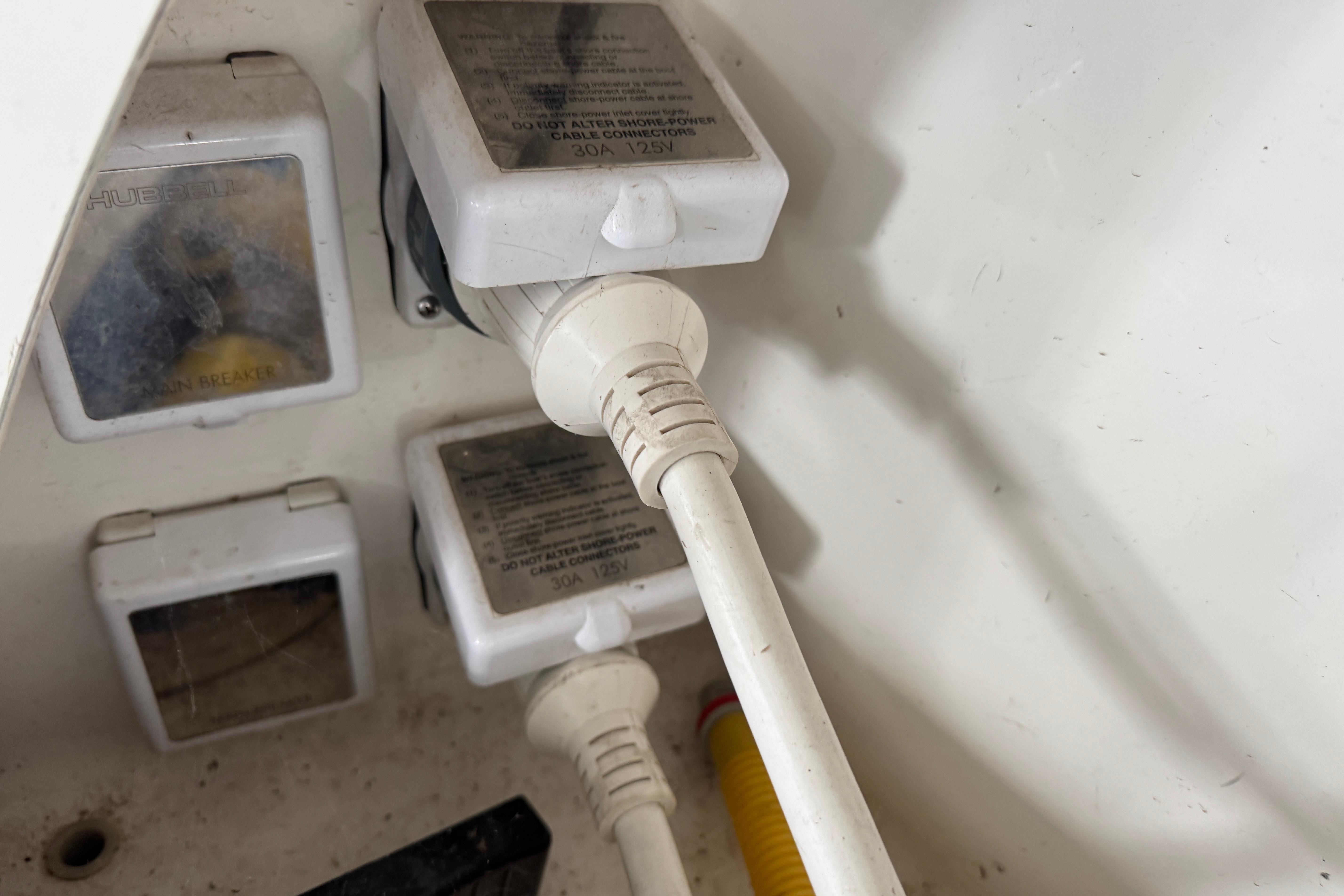 Electrical connections on a 2006 Chaparral 330 Signature boat, featuring power cables and outlets.