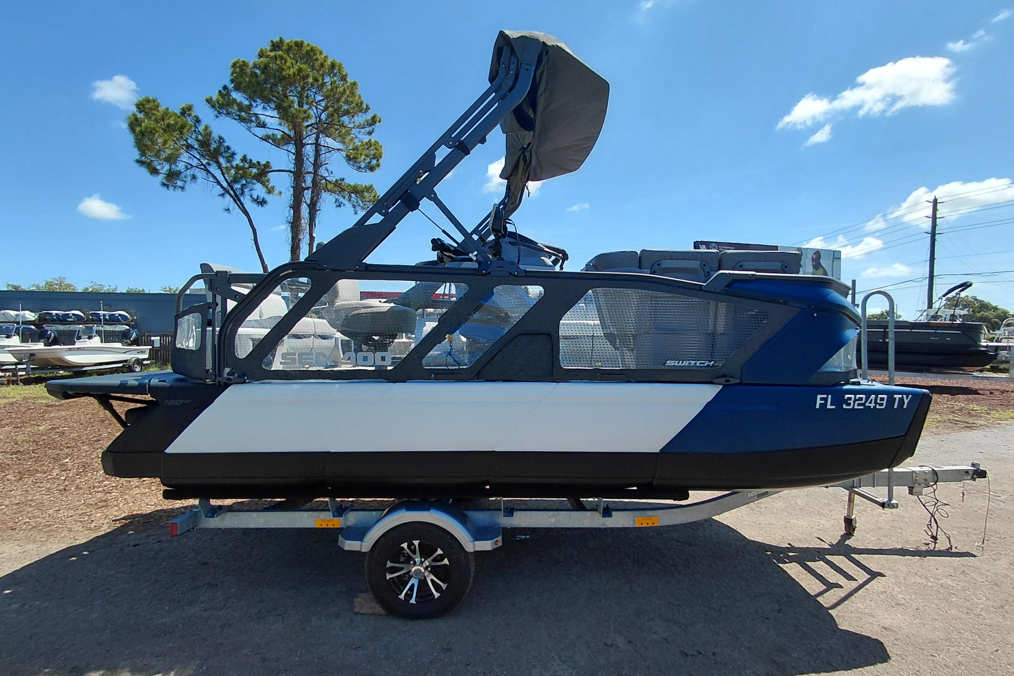2024 Sea-Doo Switch Cruise 18 pontoon boat on trailer, side view, outdoors.