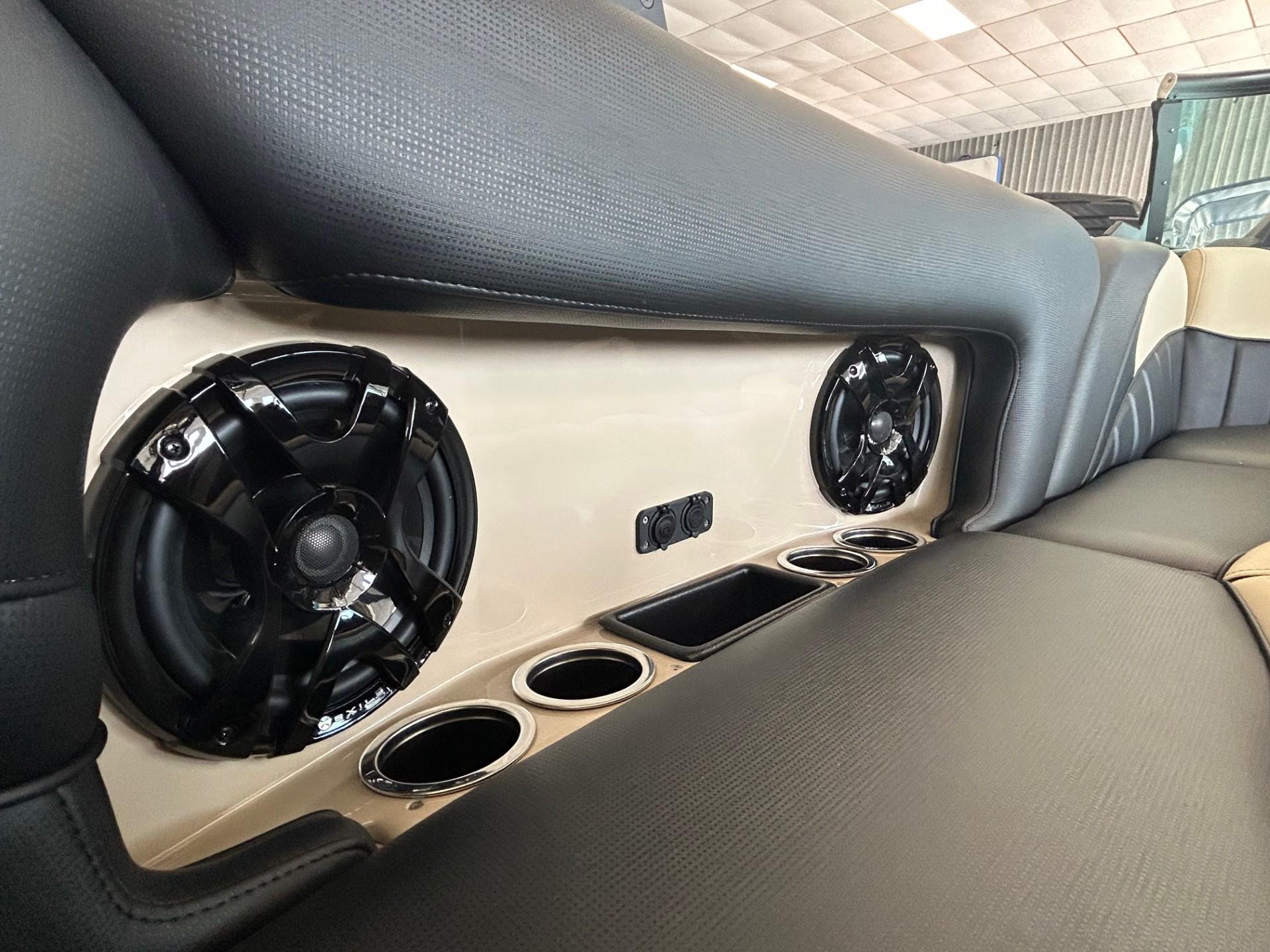 2024 MB F22 Tomcat interior with speakers and cup holders in rear seating area.