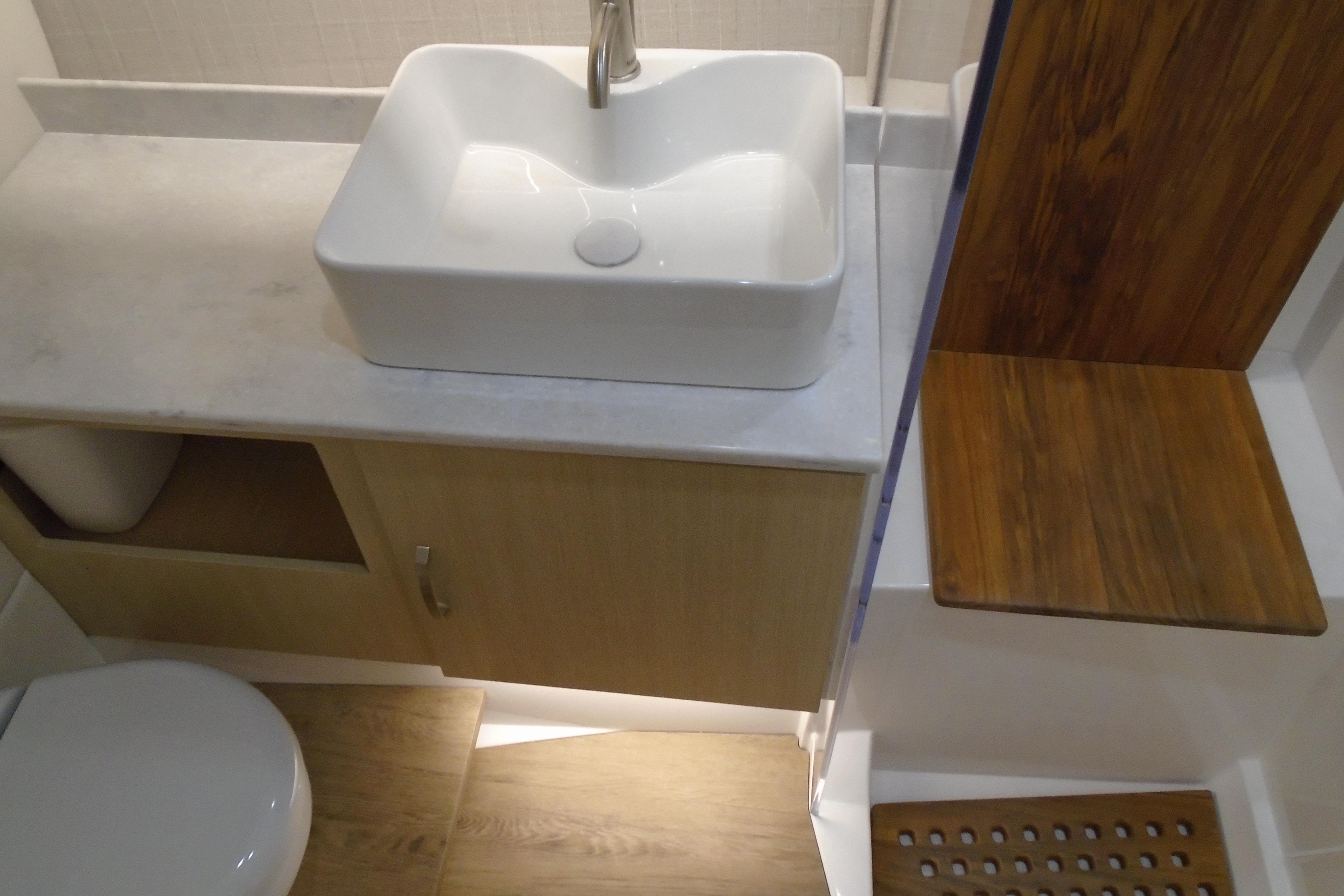 Modern bathroom interior in 2026 Regal 38 SAV yacht with sink and wooden accents.