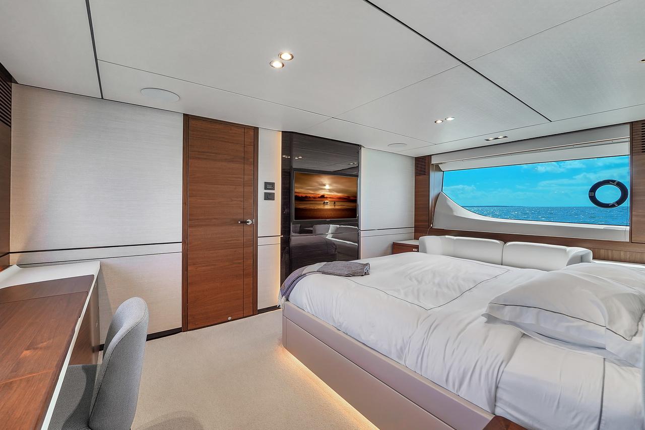 Luxurious bedroom interior of 2021 Princess Y78 yacht with ocean view.