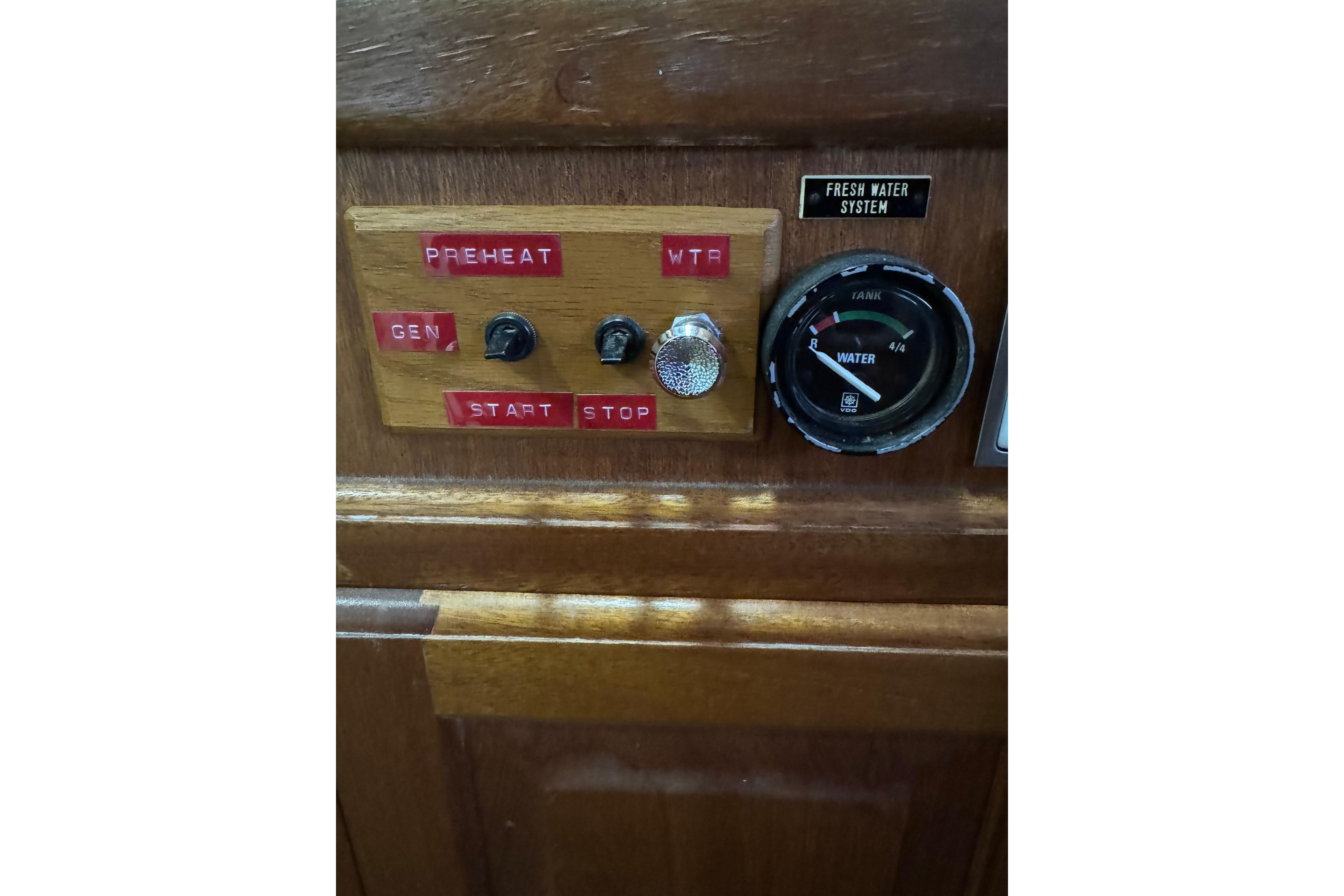 Control panel of 1978 Californian 42 LRC boat with water gauge and switches.
