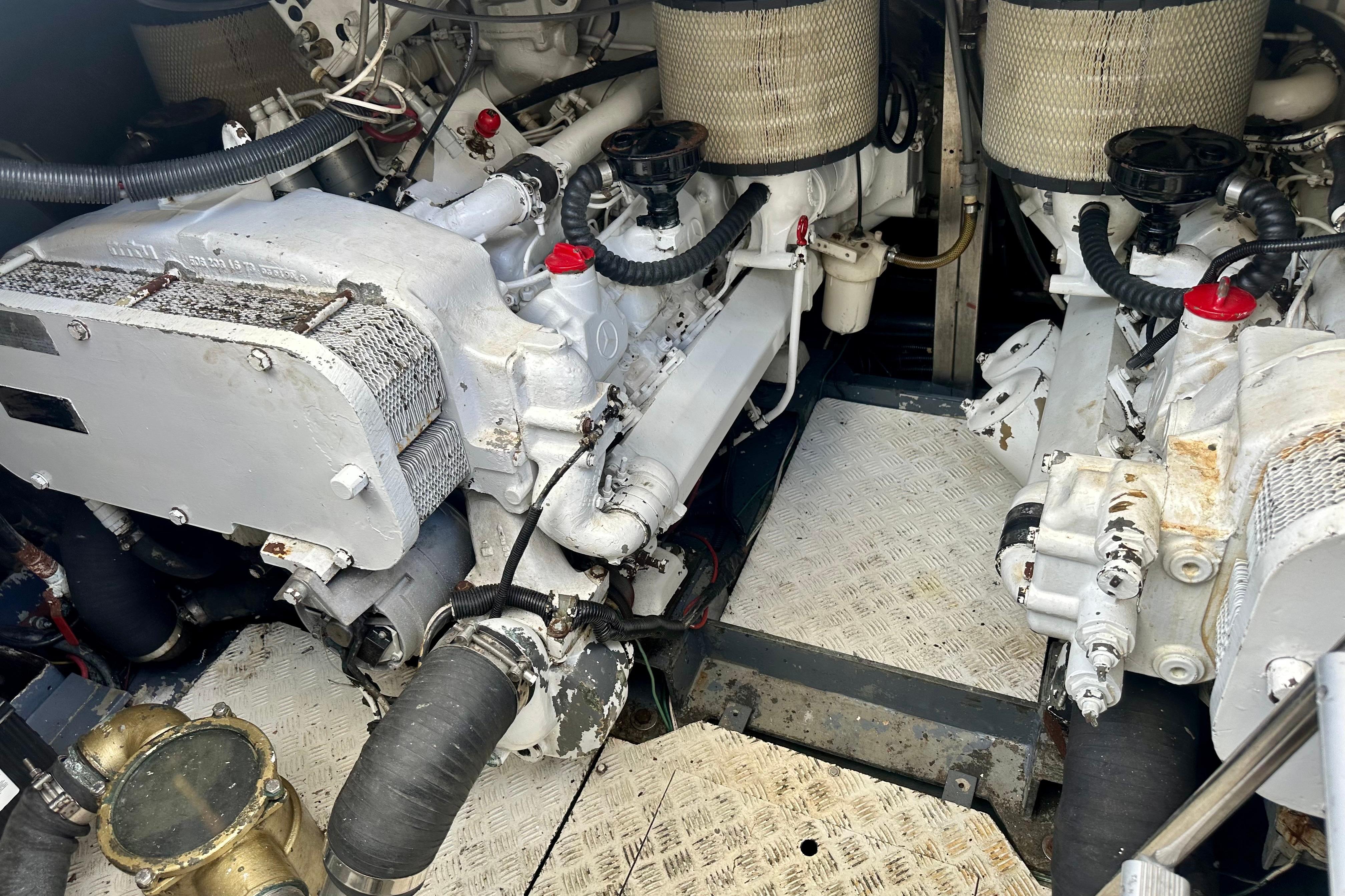 Engine room of a 1999 Azimut 58 yacht, showcasing dual engines and mechanical components.