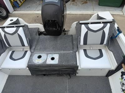 Interior view of a Crestliner 1600 Vision boat with two seats and a motor.