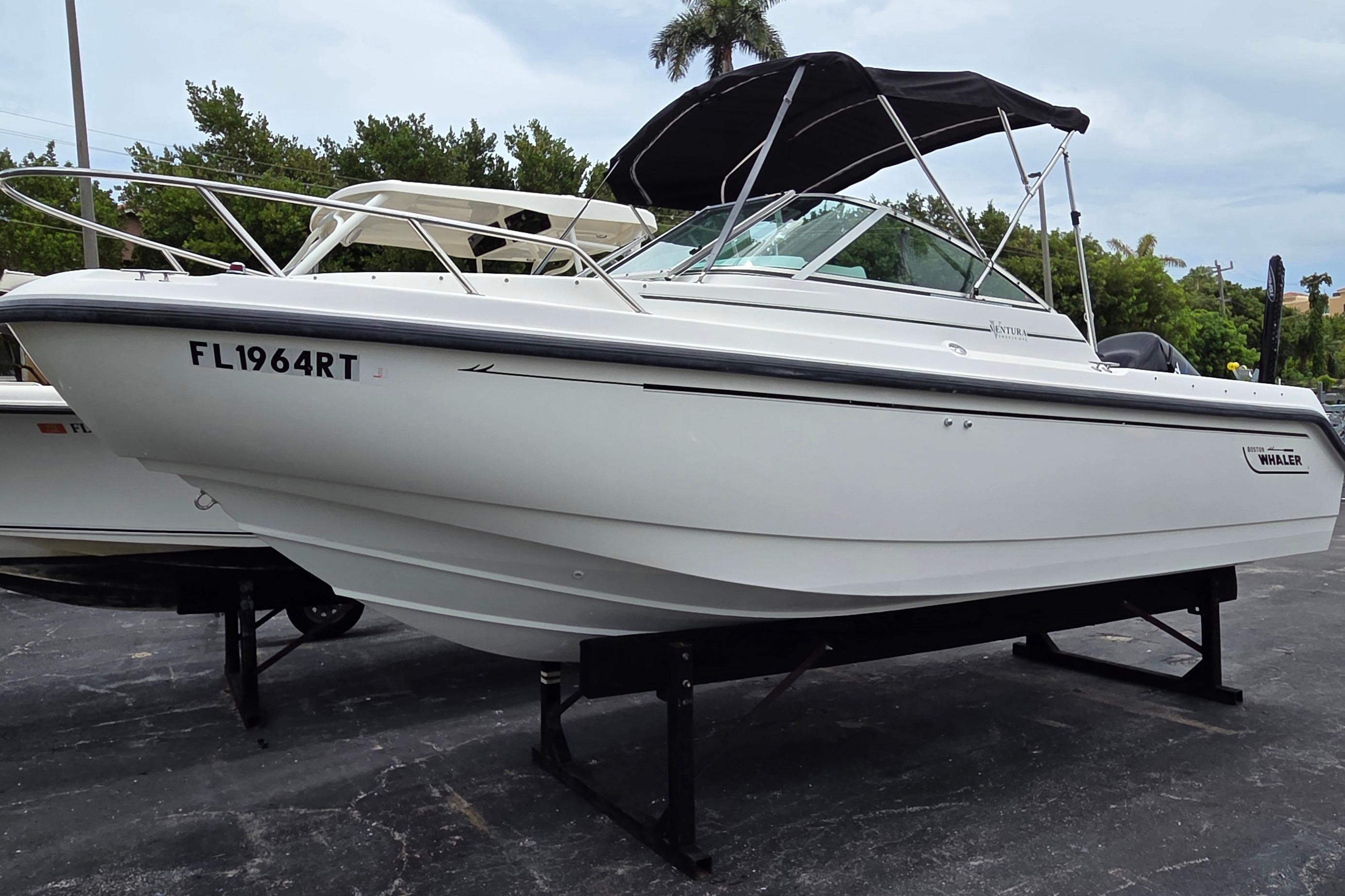 2000 Boston Whaler 21 Ventura boat with canopy on display, parked on a stand.