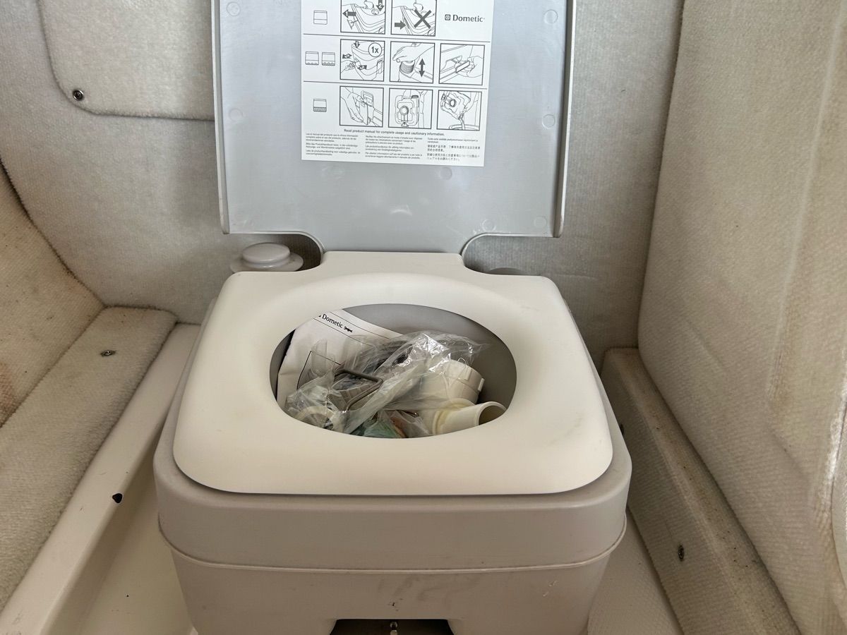 A portable boat toilet inside a 2016 Chaparral Vortex 243 VRX.