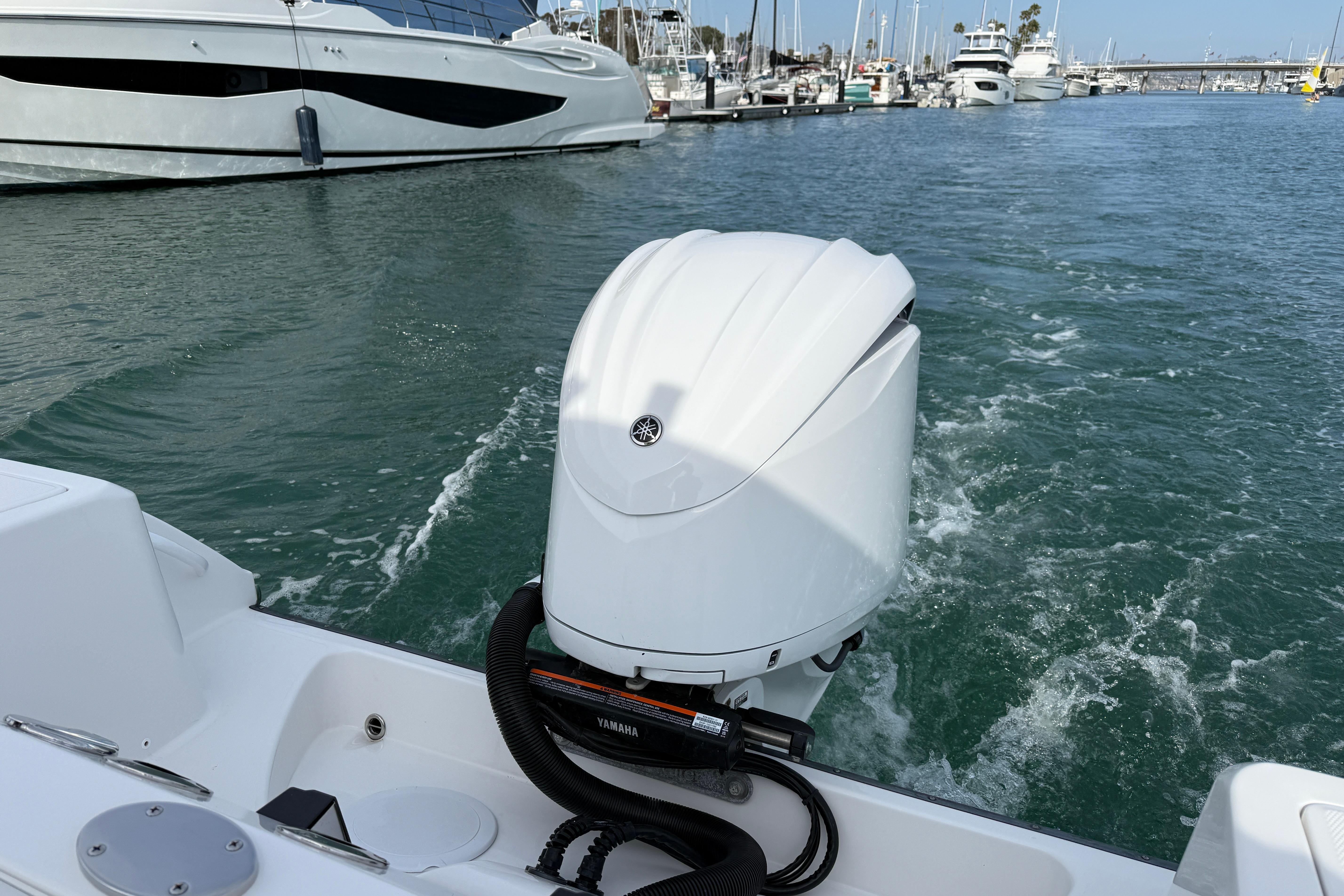 Edgewater 245CC 2023 boat with Yamaha outboard motor in a marina setting.