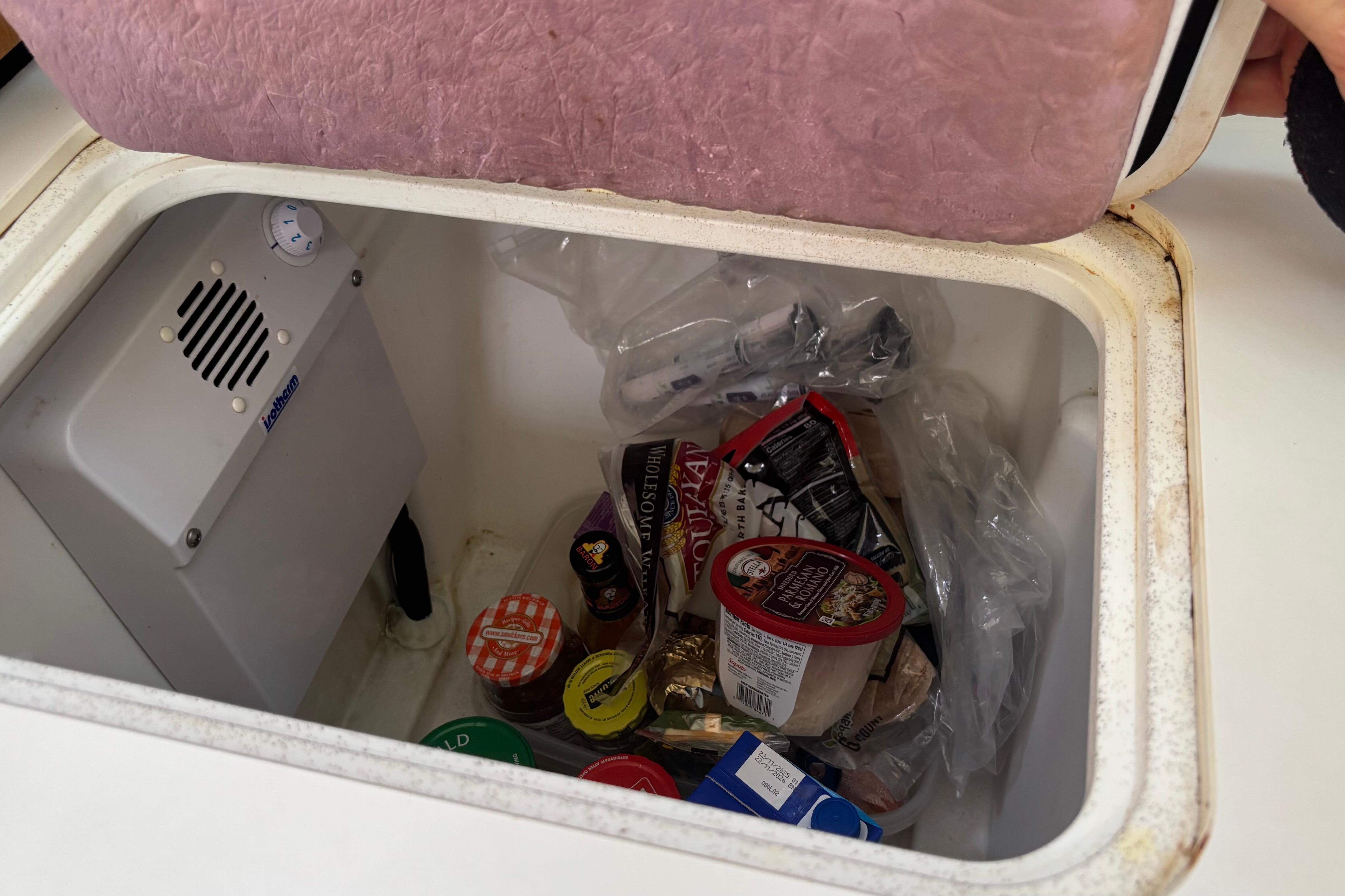 Storage compartment with assorted food items on Bavaria Cruiser 51 yacht, 2017 model.