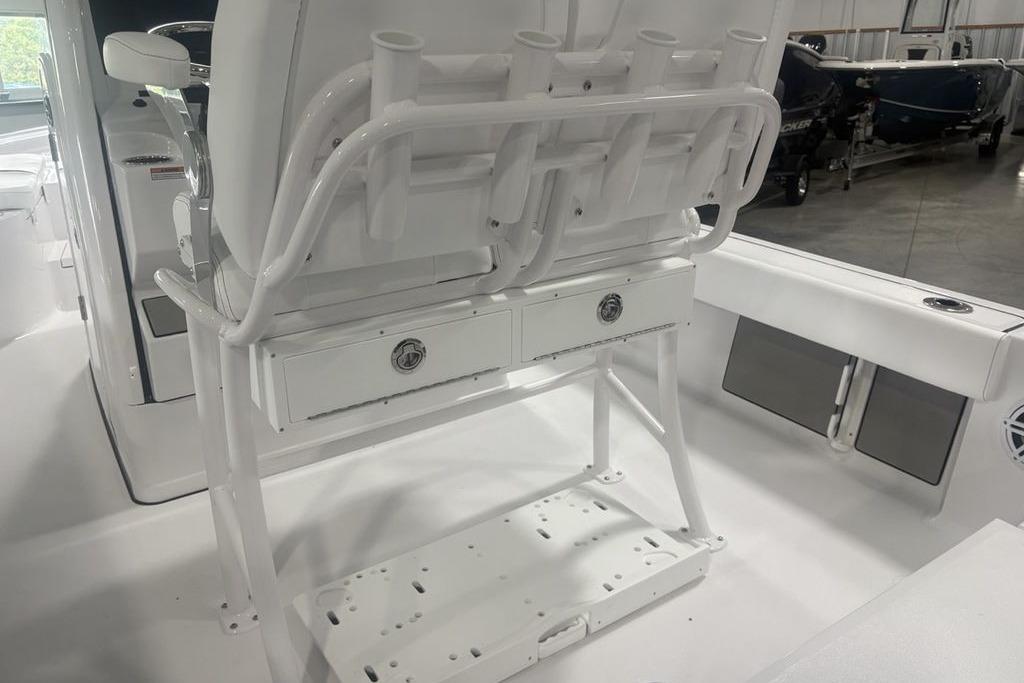 2026 Sportsman Masters 227 boat interior with rod holders and storage drawers.