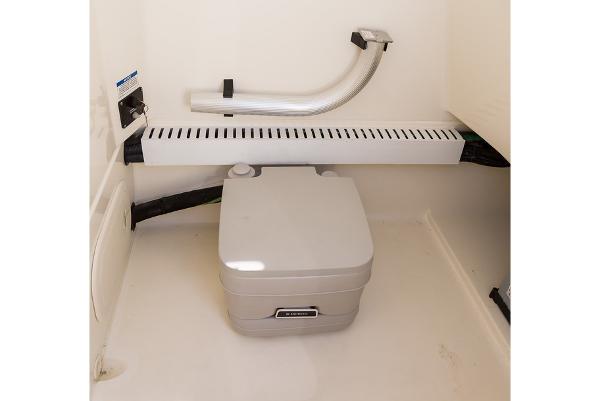Manufacturer Provided Image: 2024 Boston Whaler 230 Outrage boat interior with portable toilet.