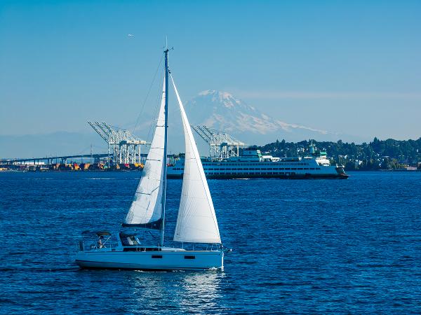 2021 Beneteau Oceanis 38.1 sailboat on water with mountain backdrop.