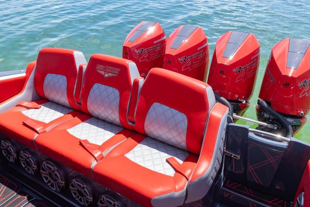 2022 Deep Impact 399 Sport boat with red seating and four powerful outboard engines.