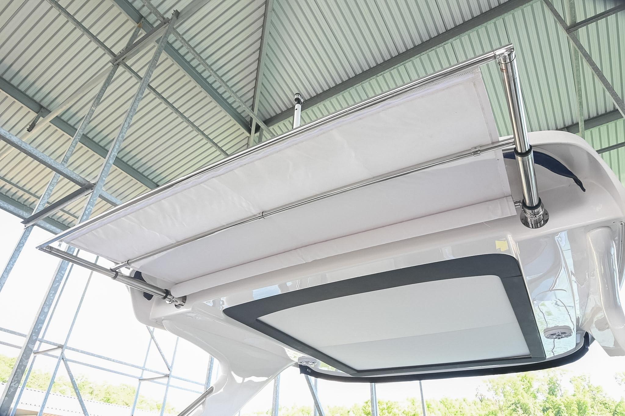 2021 Regal 33 Express boat canopy under a metal roof structure.