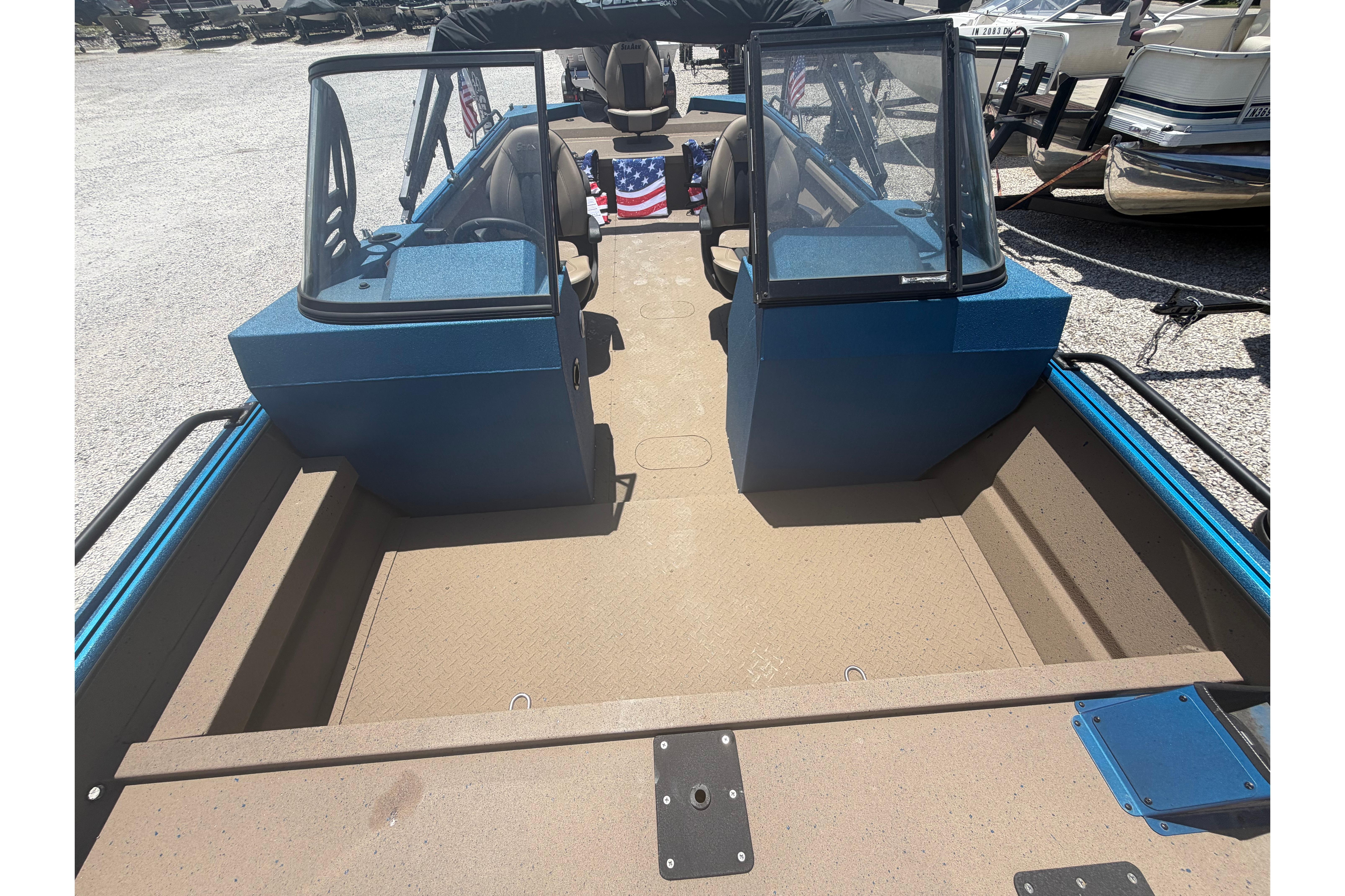 2025 SeaArk Protege 240 boat interior with blue console and seating, parked outdoors.