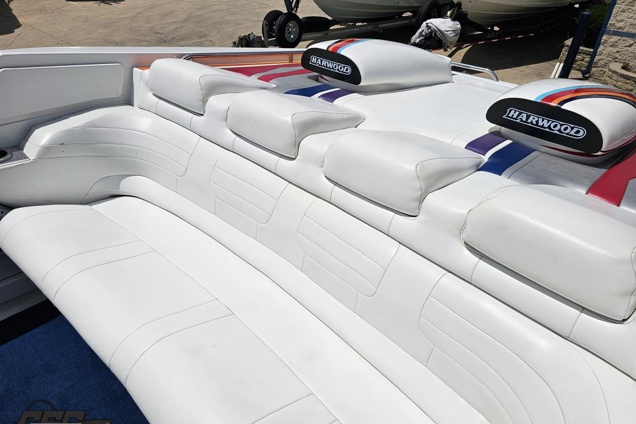 2002 Formula 382 FASTech boat interior with white leather seating and colorful accents.