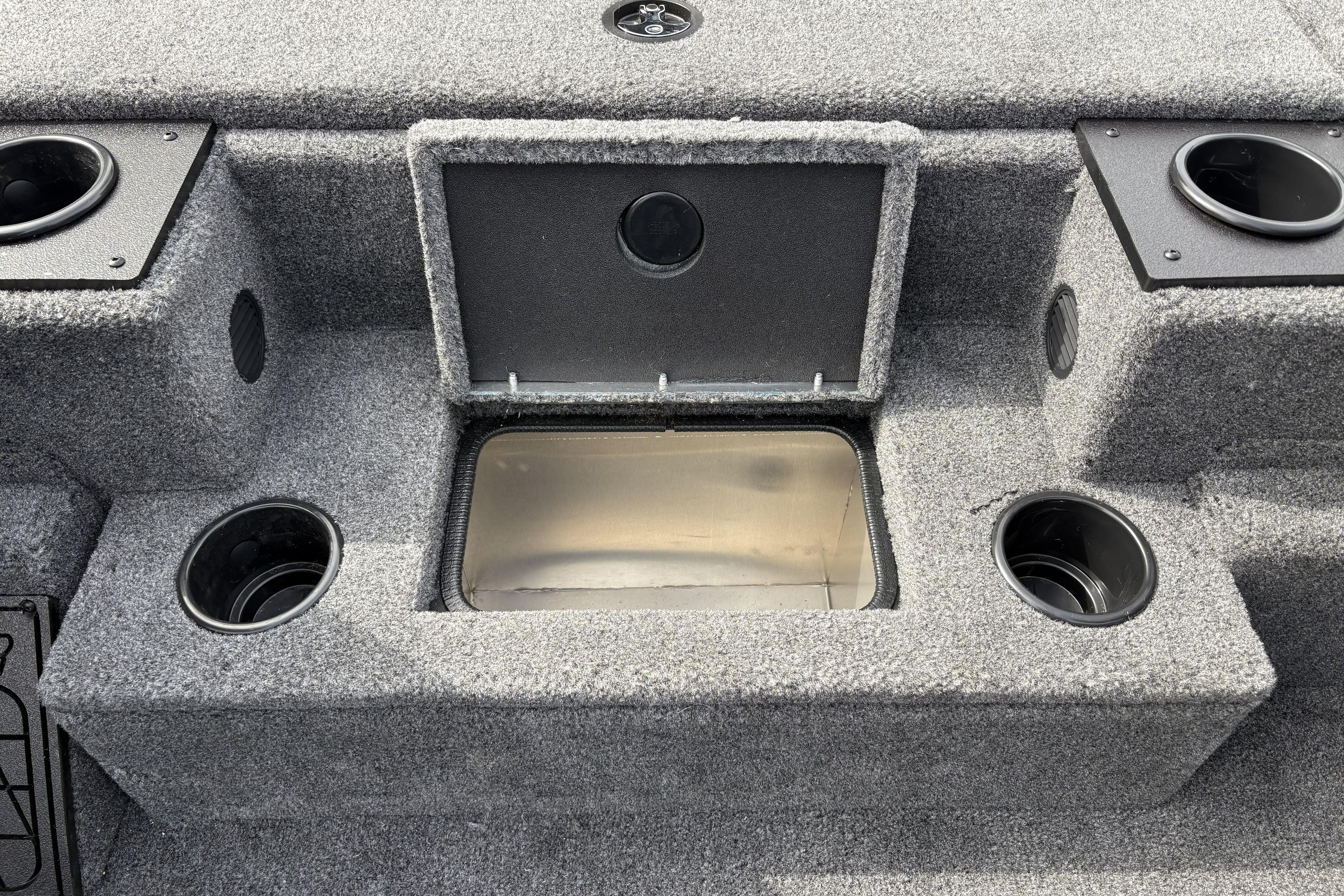 Interior of 2026 Tracker Pro Team 195 boat with storage compartment and cup holders.