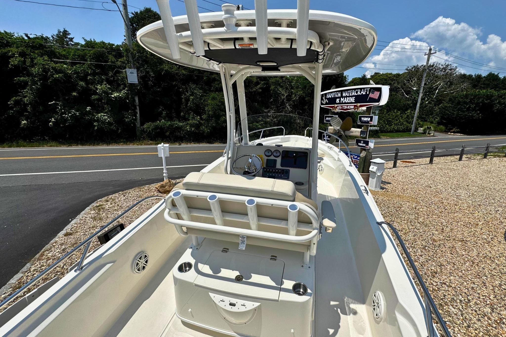 2026 Boston Whaler 220 Dauntless boat with center console, parked near a road.