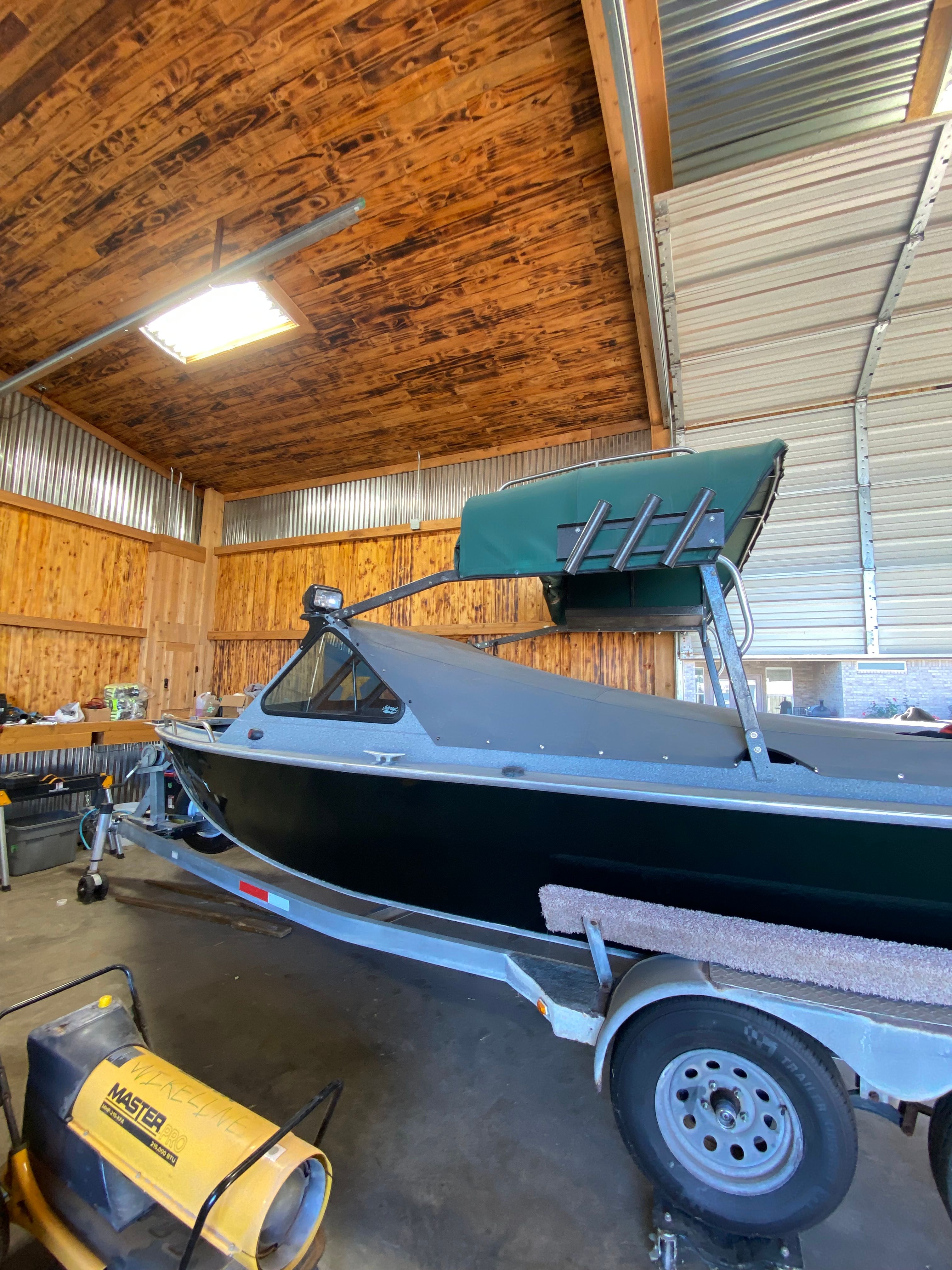 1993 Jetcraft Fastwater boat parked in wooden garage.