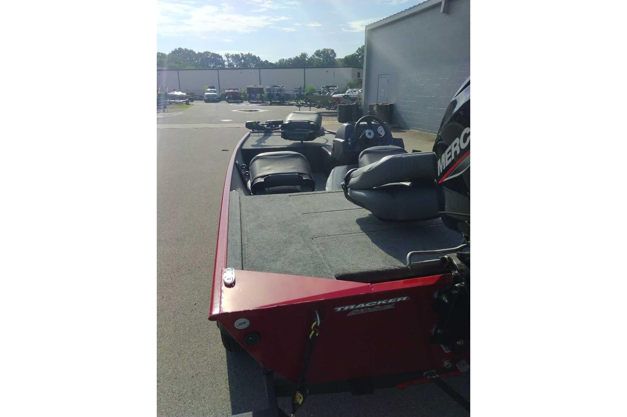 2026 Tracker Bass Tracker Classic XL boat, red exterior, parked outdoors near a building.