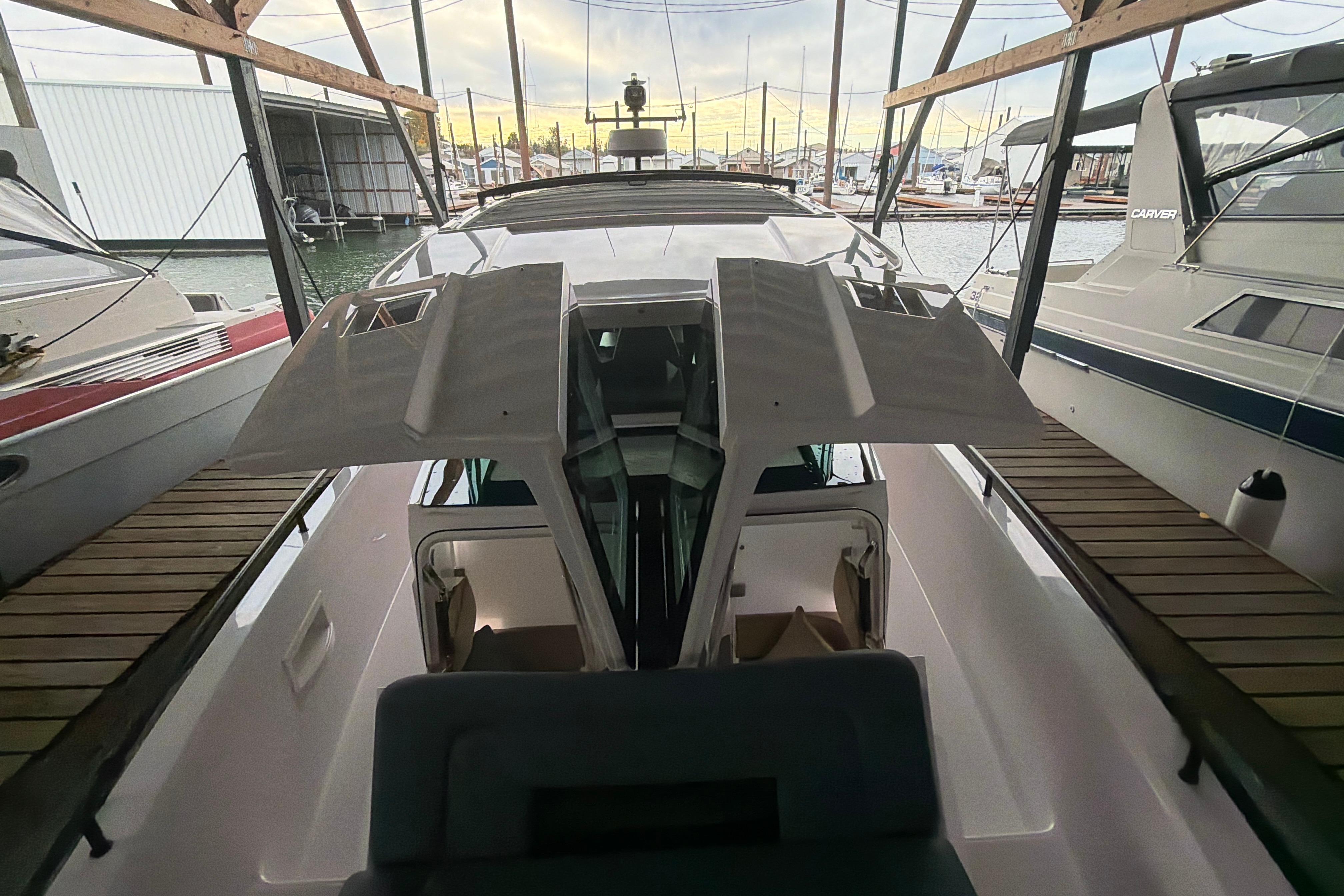 2022 Axopar Brabus 37 XC Cross Cabin docked in a marina, showcasing sleek design.