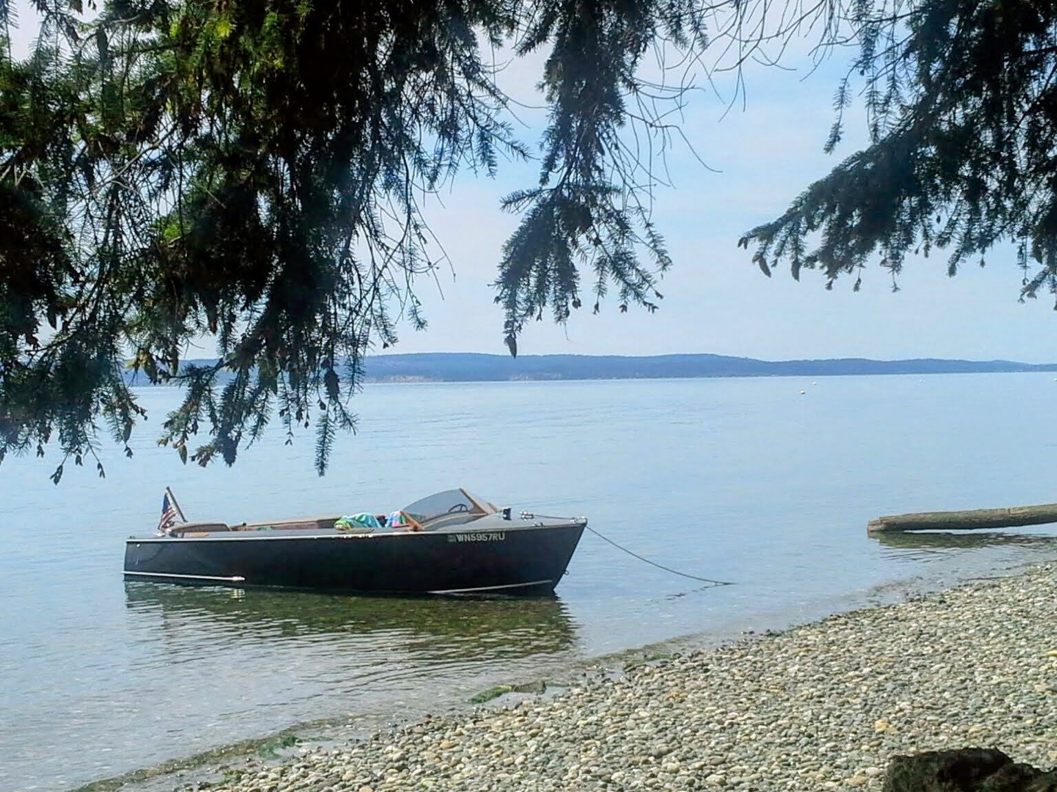 1948 Higgins 17.5 ft Runabout at tranquil lakeside.